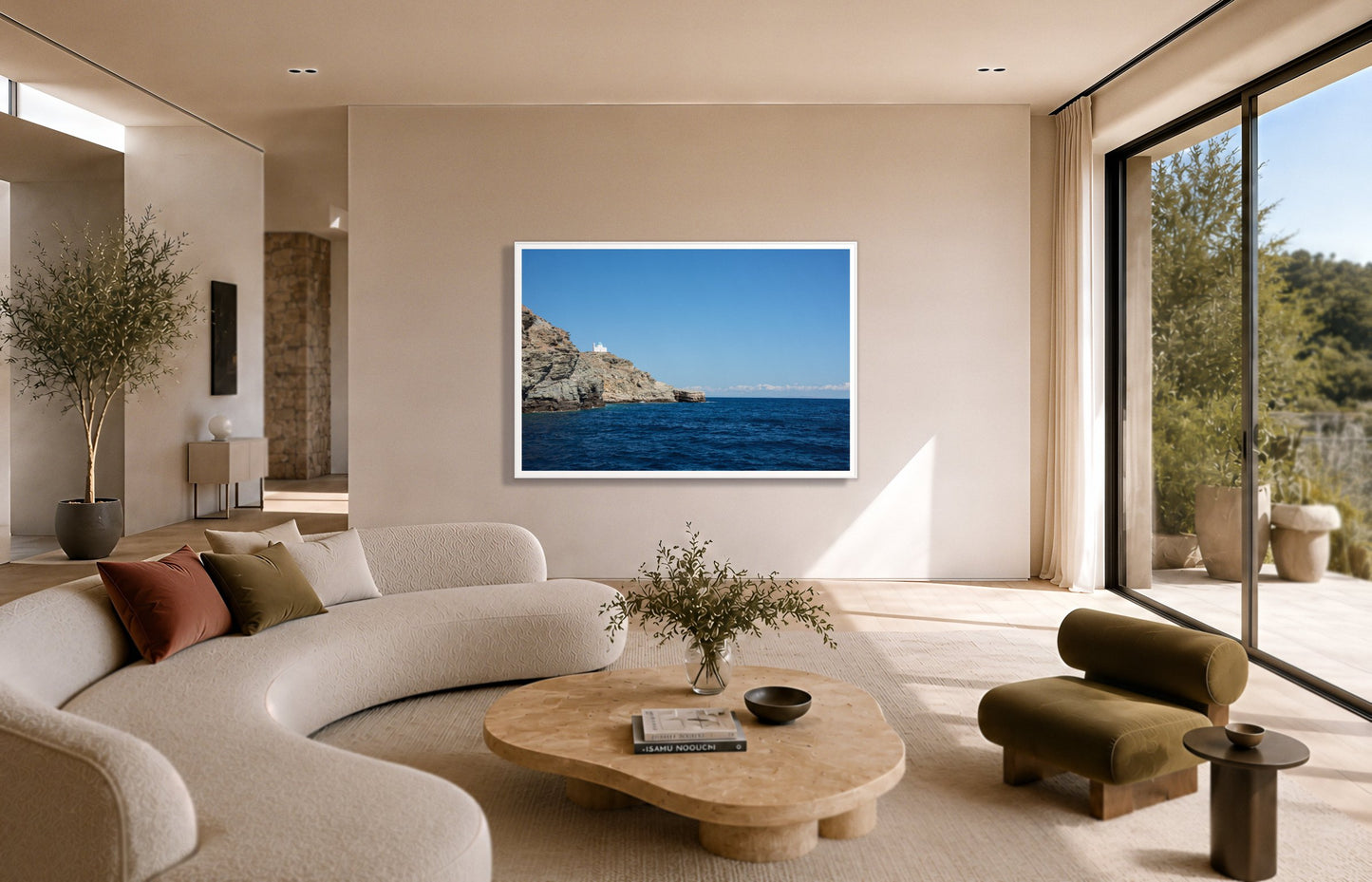 Church On The Edge by Dylan Ozanich in a White frame, above a cream curved sofa in a sunlit room with olive velvet seating
