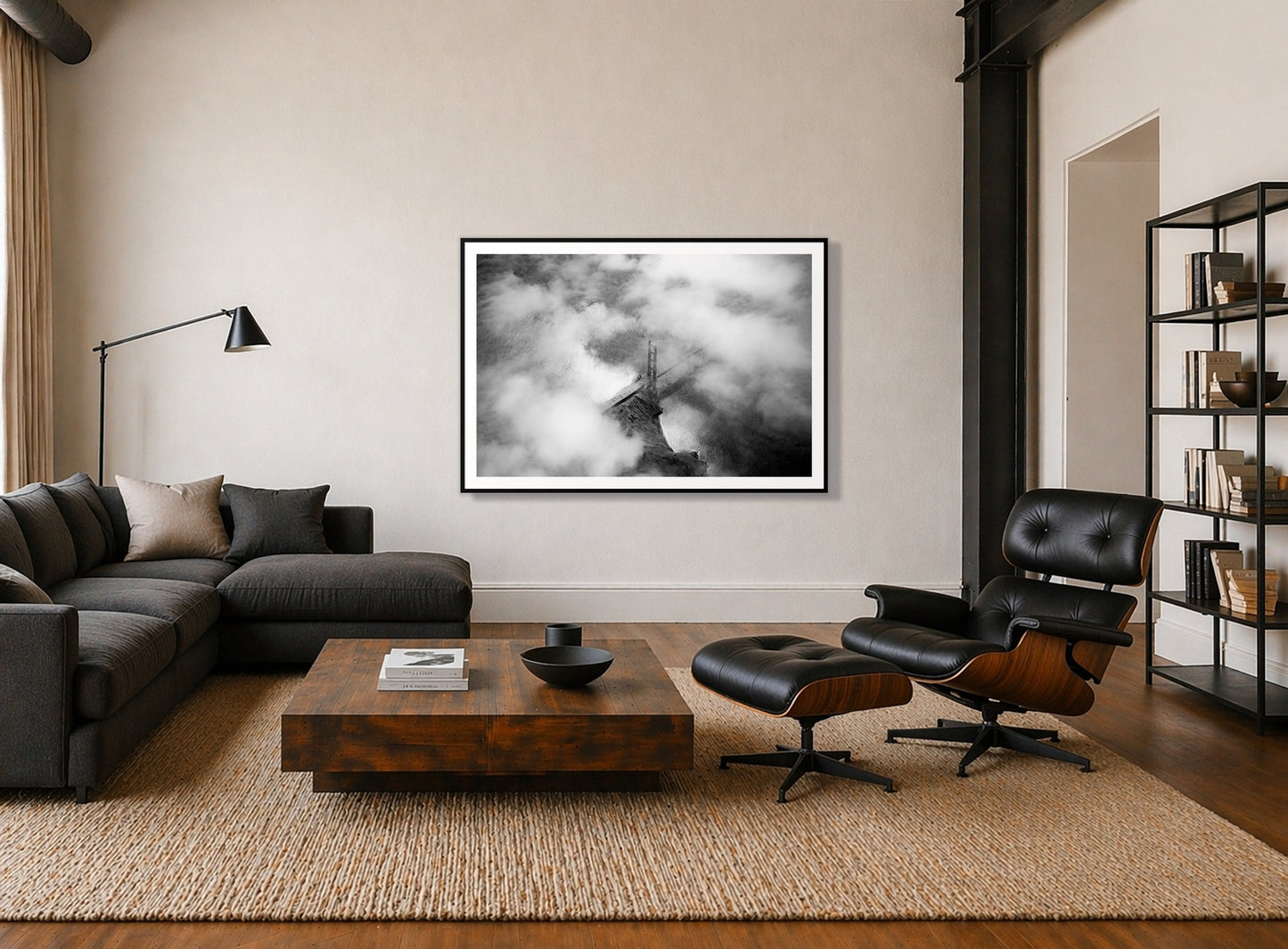 Golden Gate Fog by Dylan Ozanich in a Black frame, above a dark sectional in a loft with a black leather lounge chair