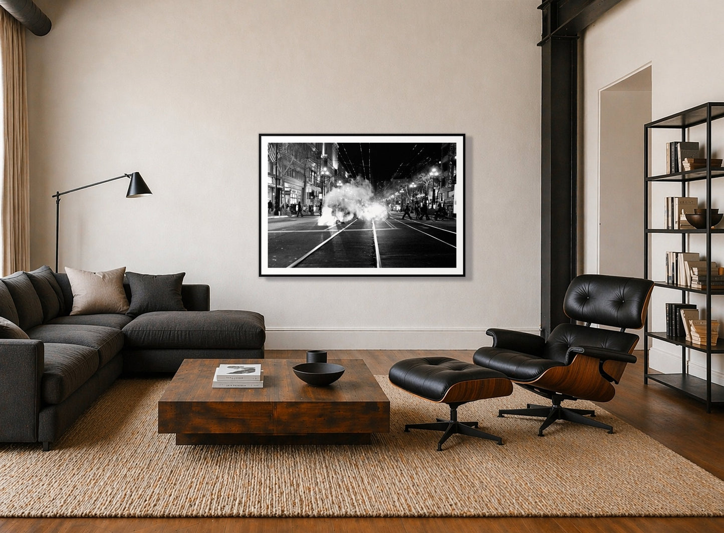 Market Street by Dylan Ozanich in a Black frame, above a dark sectional in a loft with a black leather lounge chair