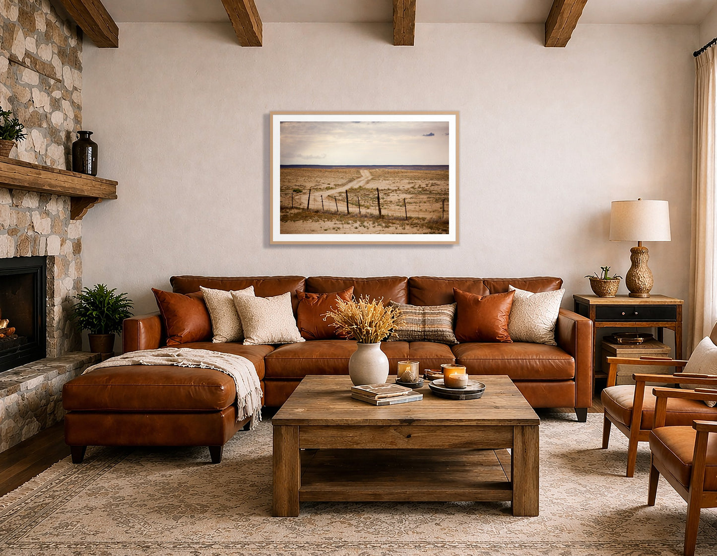 Road To Nowhere by Dylan Ozanich in an Oak frame, beside a stone fireplace above a brown leather sectional