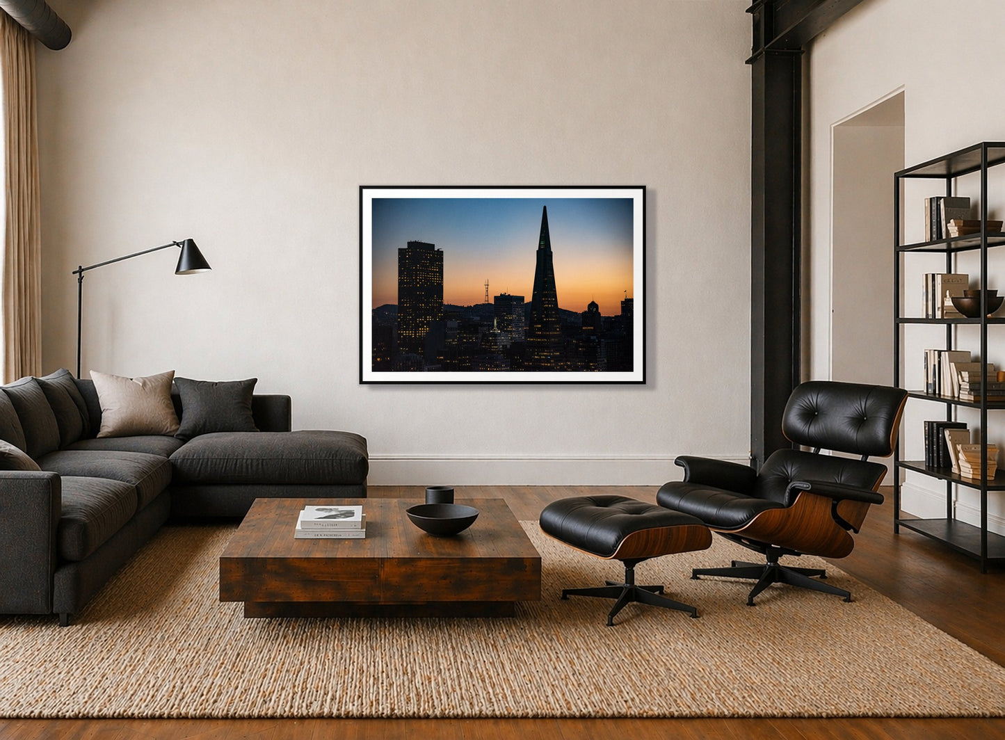 San Francisco Skyline by Dylan Ozanich in a Black frame, above a dark sectional in a loft with a black leather lounge chair