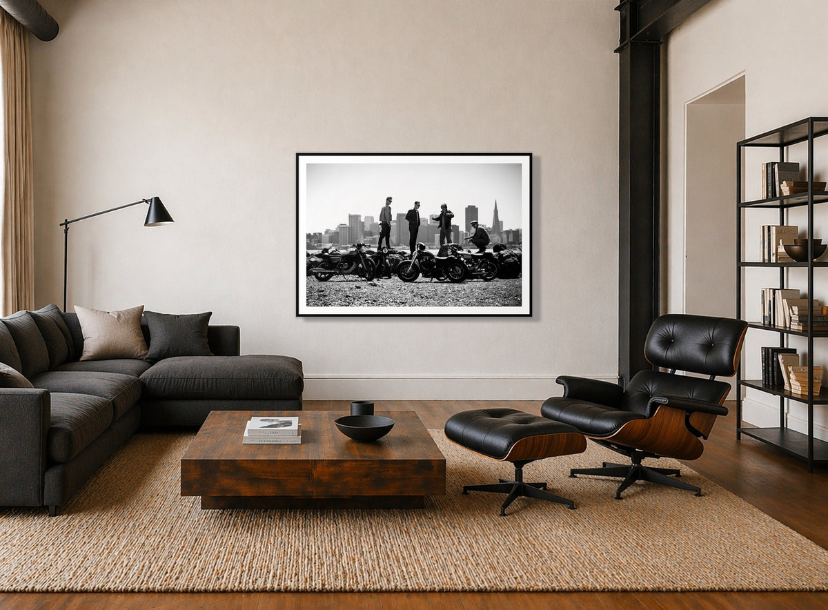 The Love For Riding by Dylan Ozanich in a Black frame, above a dark sectional in a loft with a black leather lounge chair