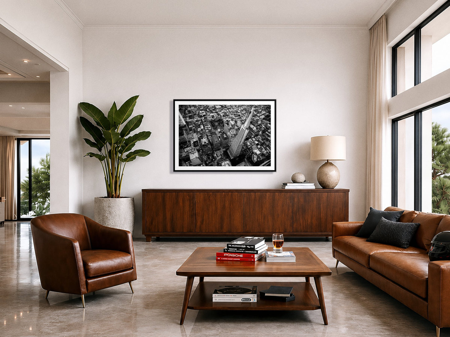 Transamerica by Dylan Ozanich in a Black frame, above a walnut credenza in a modern living room with polished stone floors