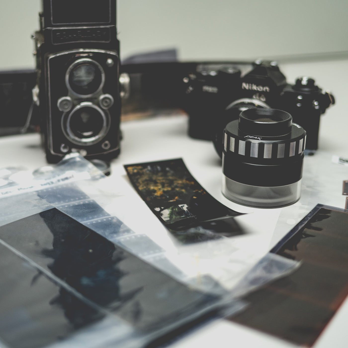 A photographer reviewing film during a studio proofing session.