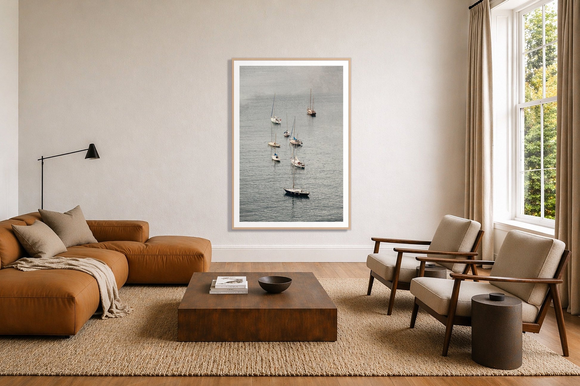 Anchored by Dylan Ozanich in an Oak frame, above a tan modular leather sofa in a minimal, sunlit living room