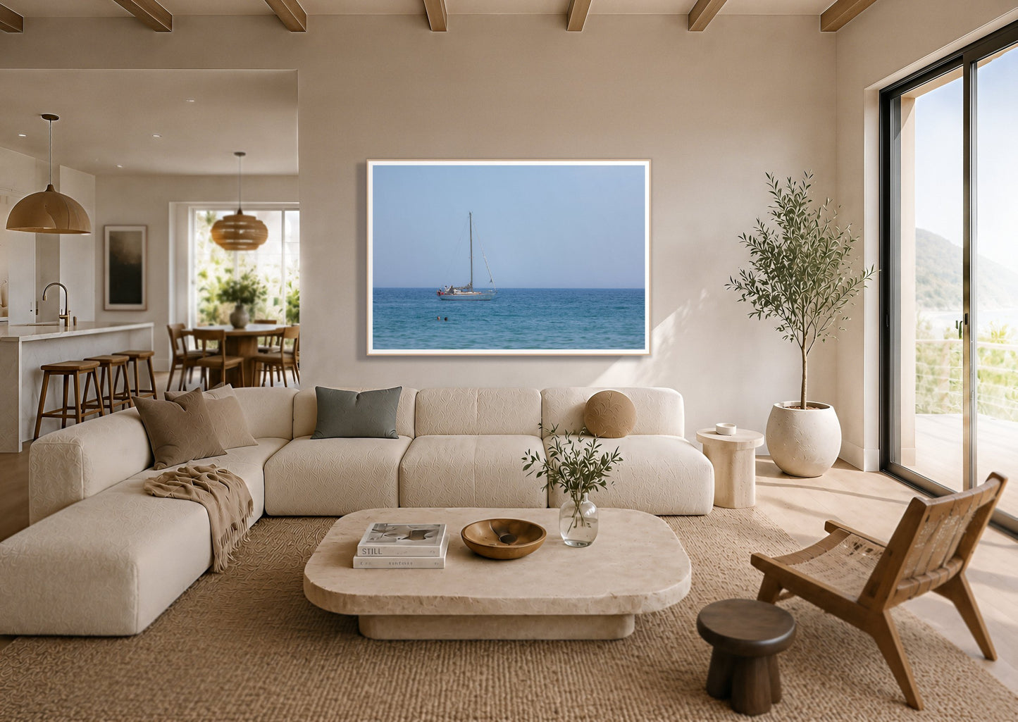 Barcelona Sea by Dylan Ozanich in an Oak frame, above a cream sectional in a coastal living room with an ocean view