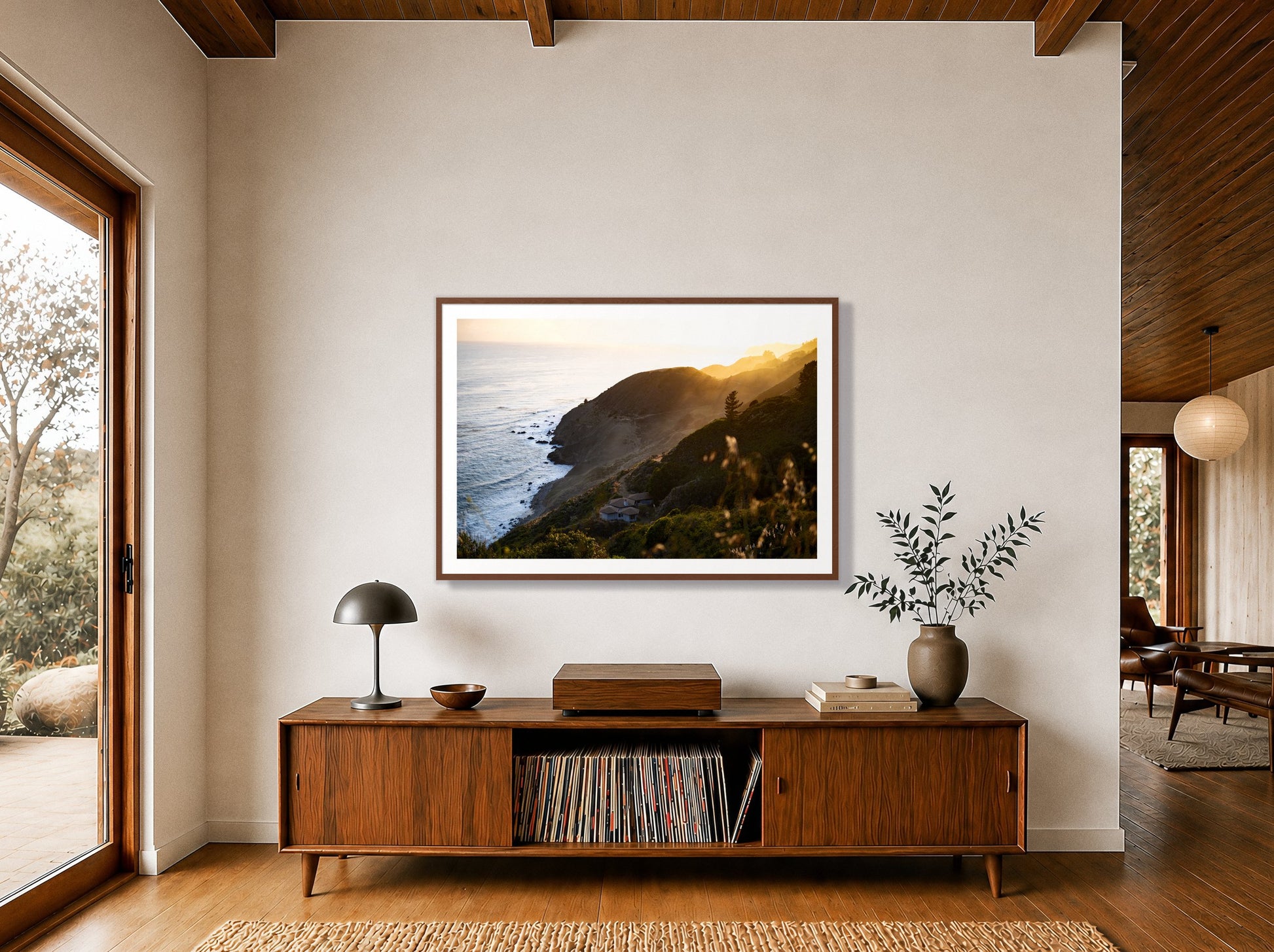 Big Sur Sunset by Dylan Ozanich in a Walnut frame, above a walnut record credenza in a wood-beamed midcentury room