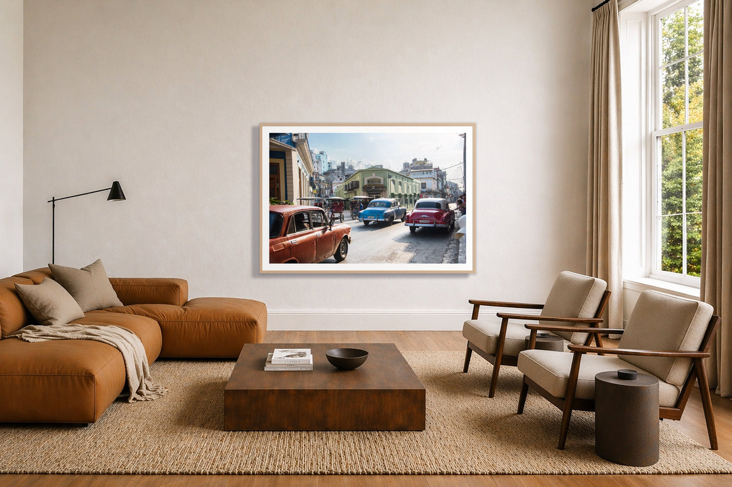 Cuba by Dylan Ozanich in an Oak frame, above a tan modular leather sofa in a minimal, sunlit living room