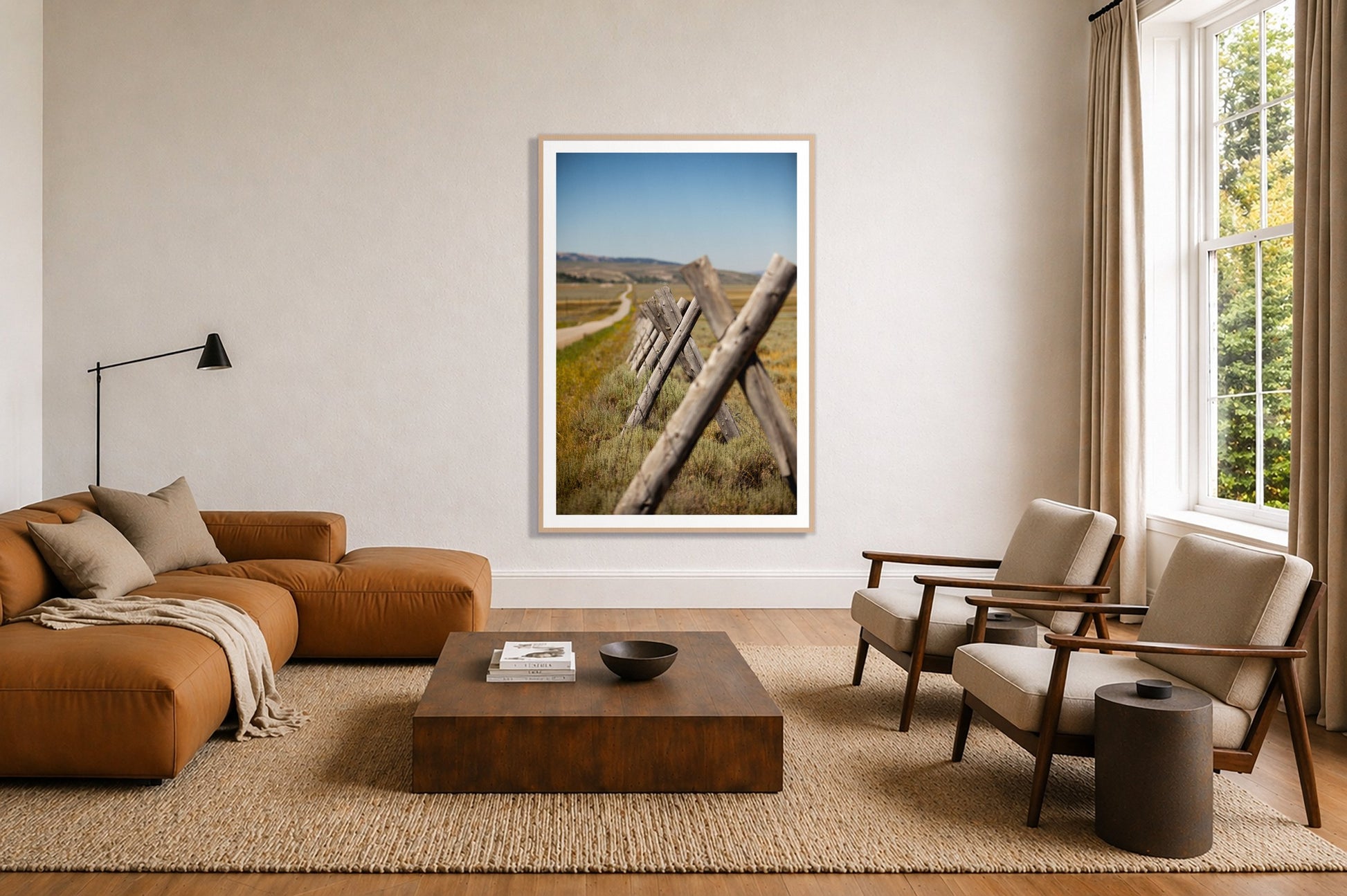 Exit Zero by Dylan Ozanich in an Oak frame, above a tan modular leather sofa in a minimal, sunlit living room