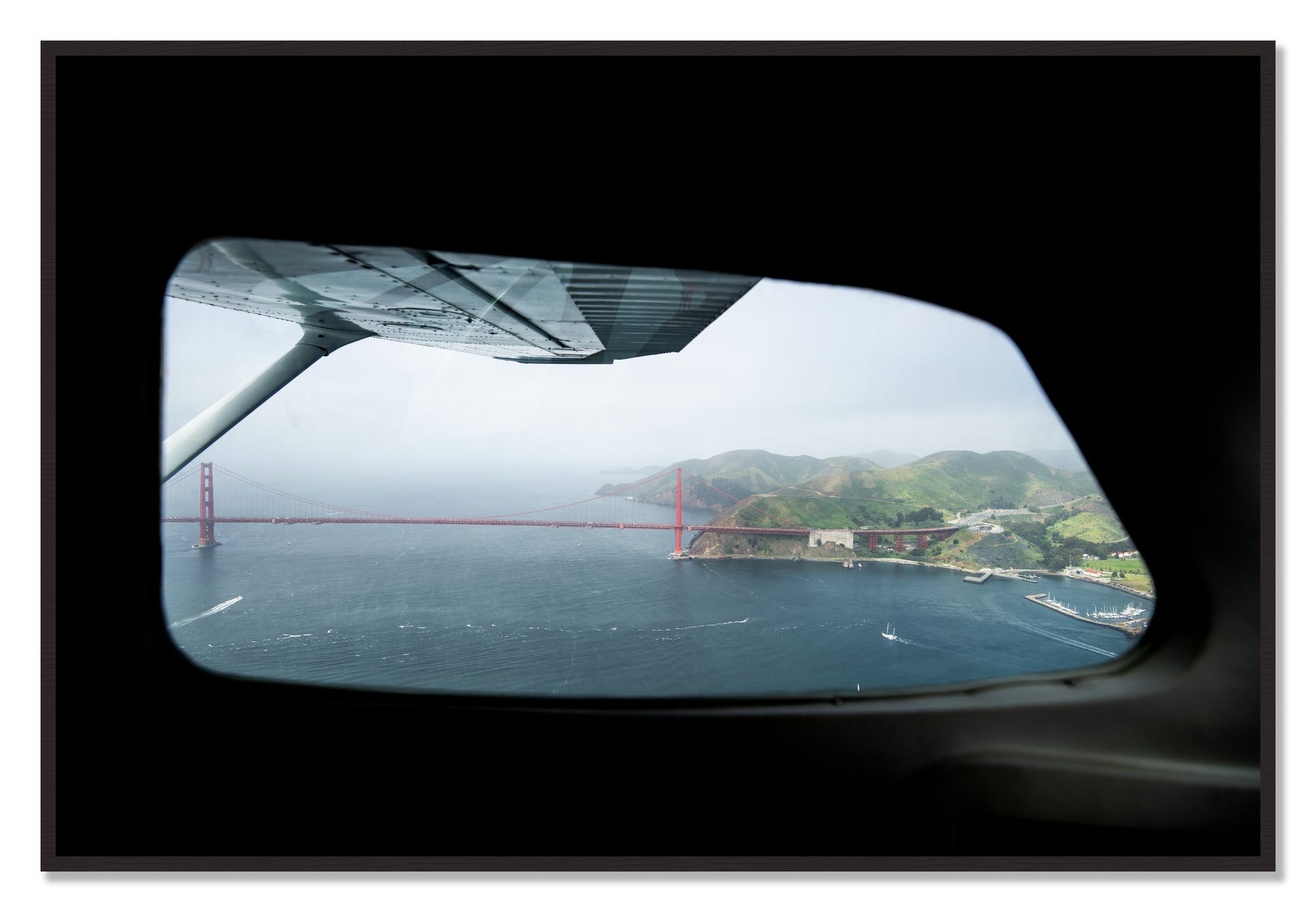 Framed photograph of Flying Over The Gate by Dylan Ozanich, Black Walnut frame, Full Bleed