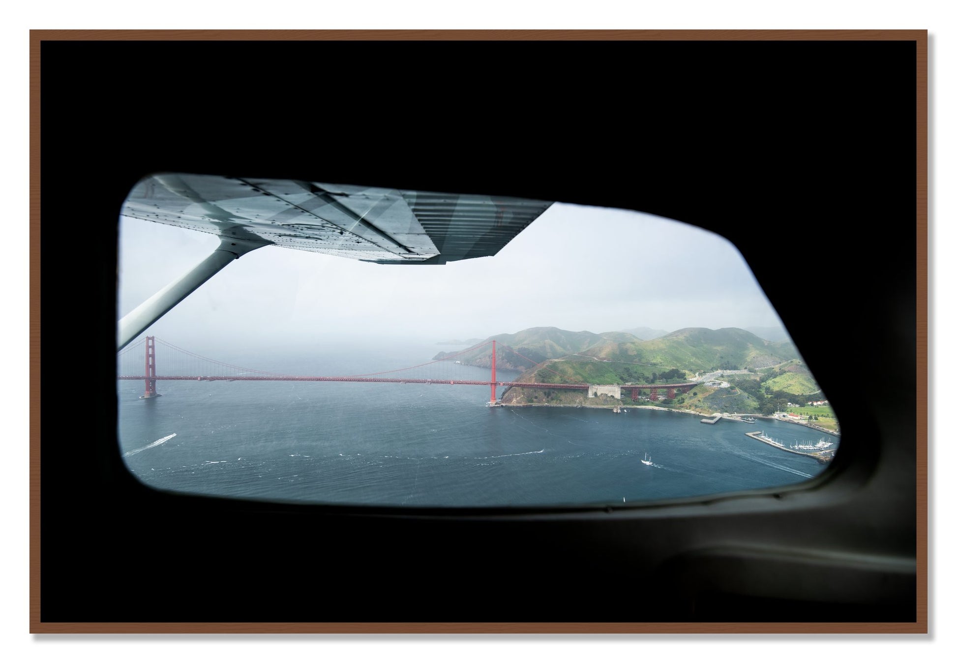 Framed photograph of Flying Over The Gate by Dylan Ozanich, Walnut frame, Full Bleed