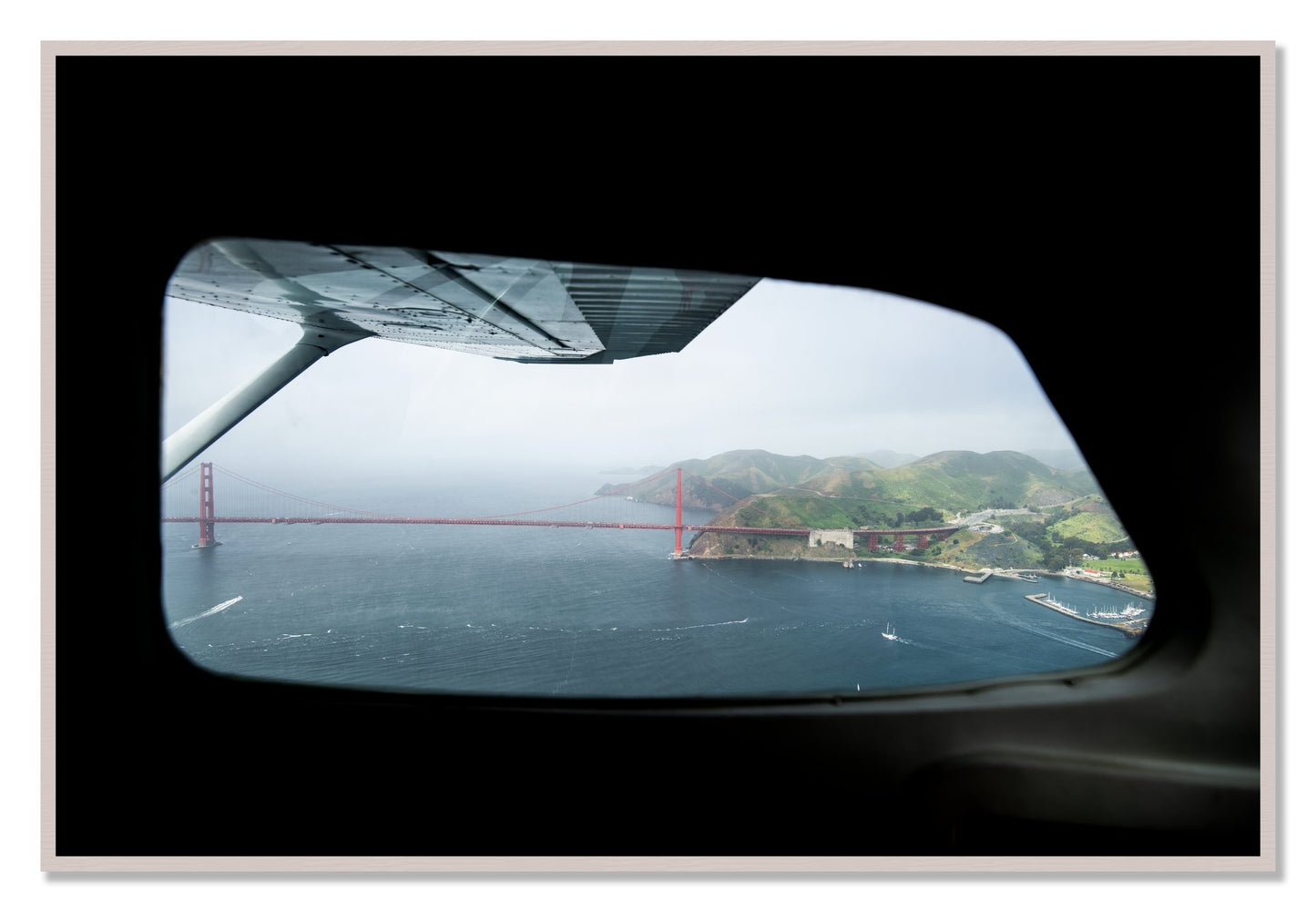 Framed photograph of Flying Over The Gate by Dylan Ozanich, White Maple frame, Full Bleed