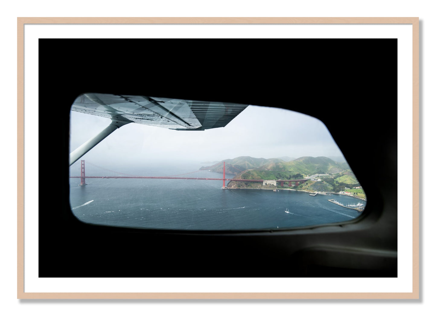 Framed photograph of Flying Over The Gate by Dylan Ozanich, Maple frame, Borders