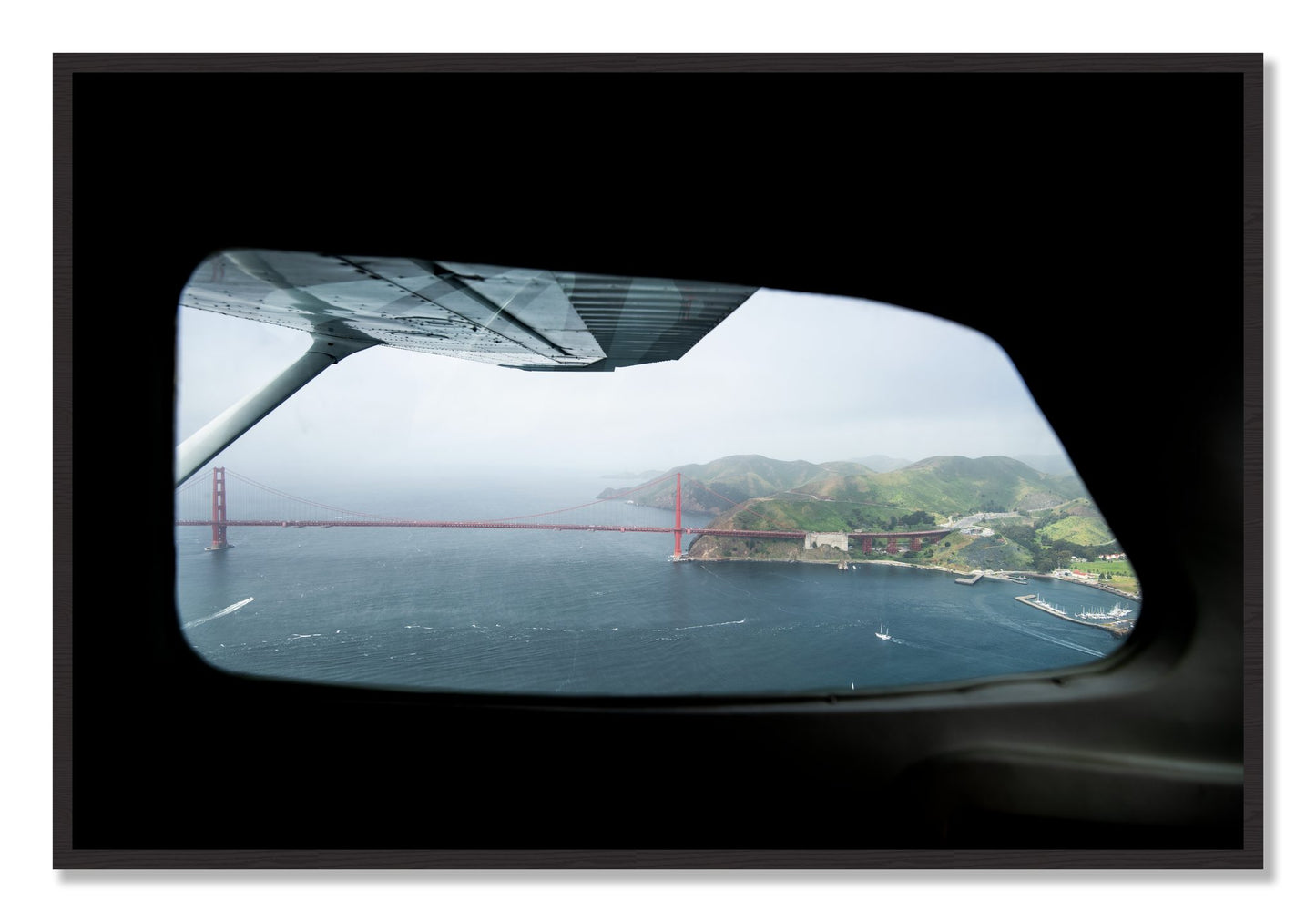 Framed photograph of Flying Over The Gate by Dylan Ozanich, Black Walnut frame, Full Bleed