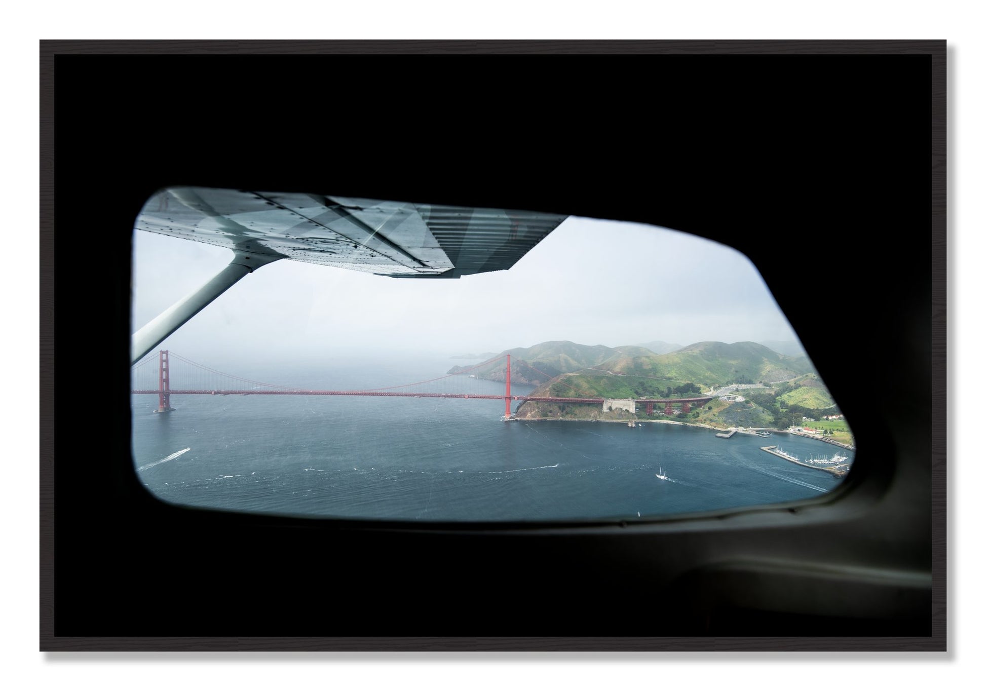 Framed photograph of Flying Over The Gate by Dylan Ozanich, Black Walnut frame, Full Bleed
