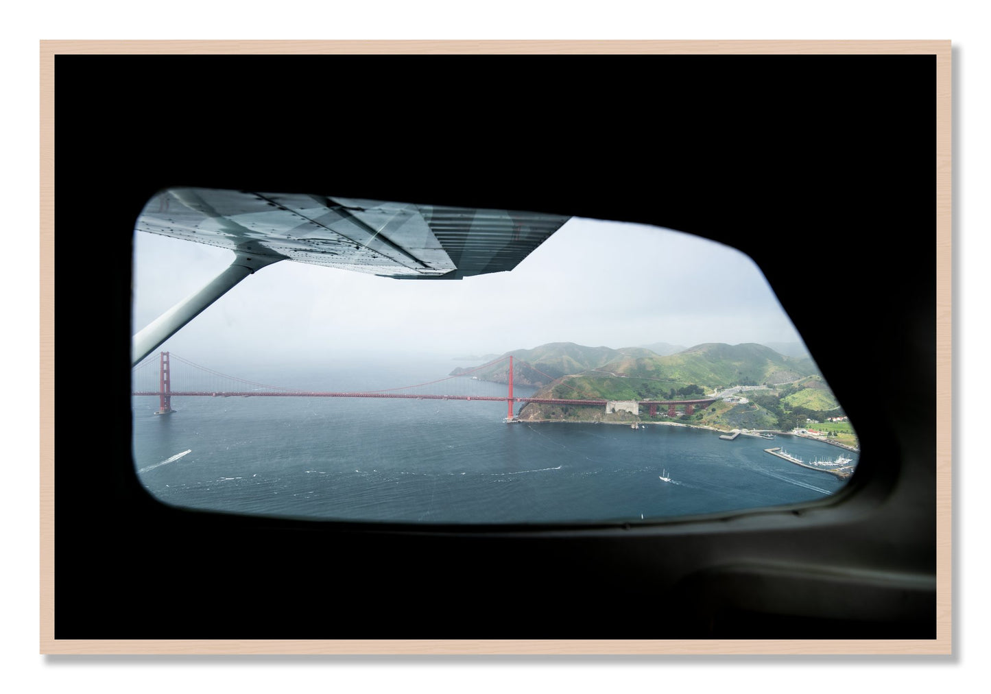 Framed photograph of Flying Over The Gate by Dylan Ozanich, Maple frame, Full Bleed