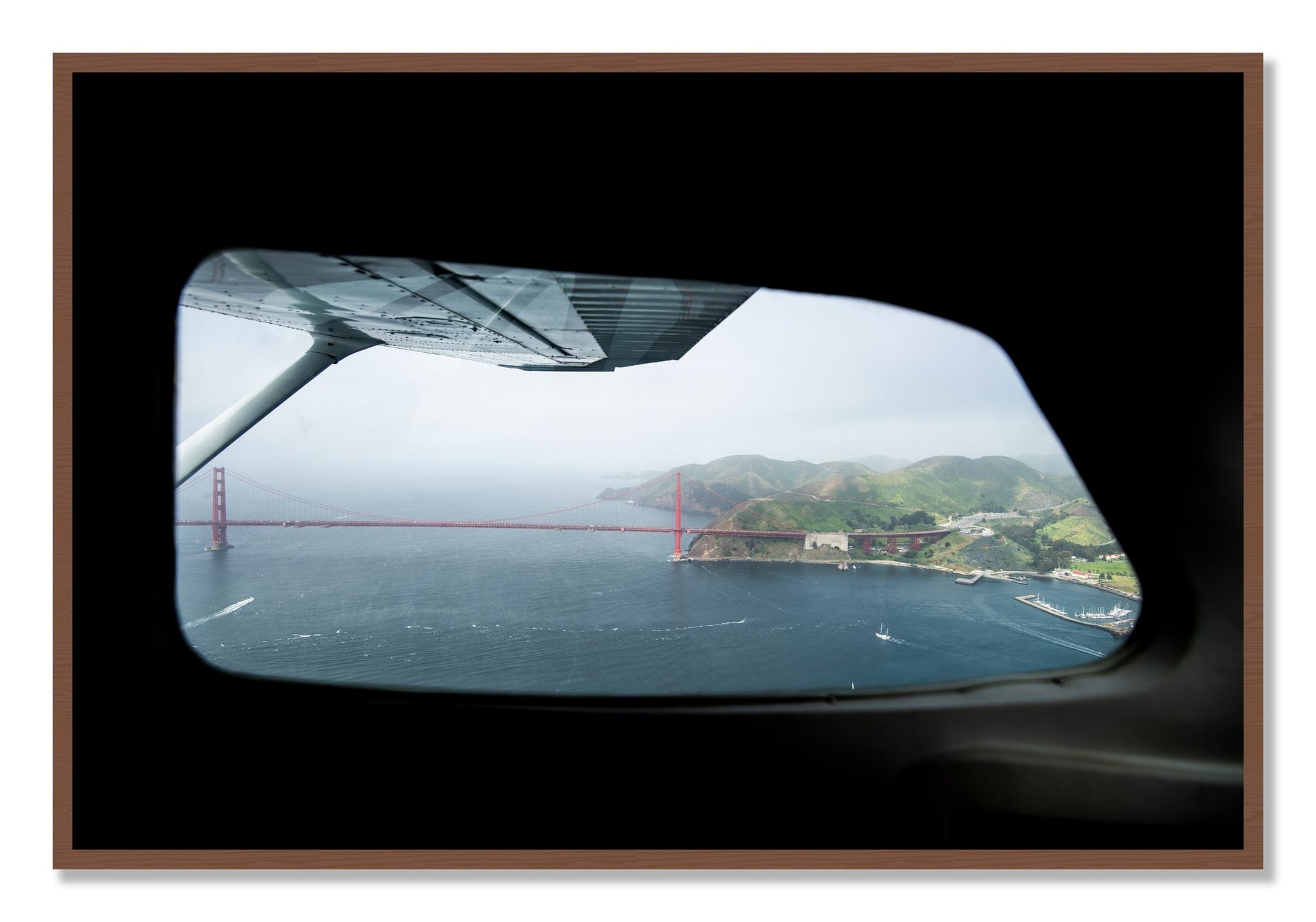 Framed photograph of Flying Over The Gate by Dylan Ozanich, Walnut frame, Full Bleed