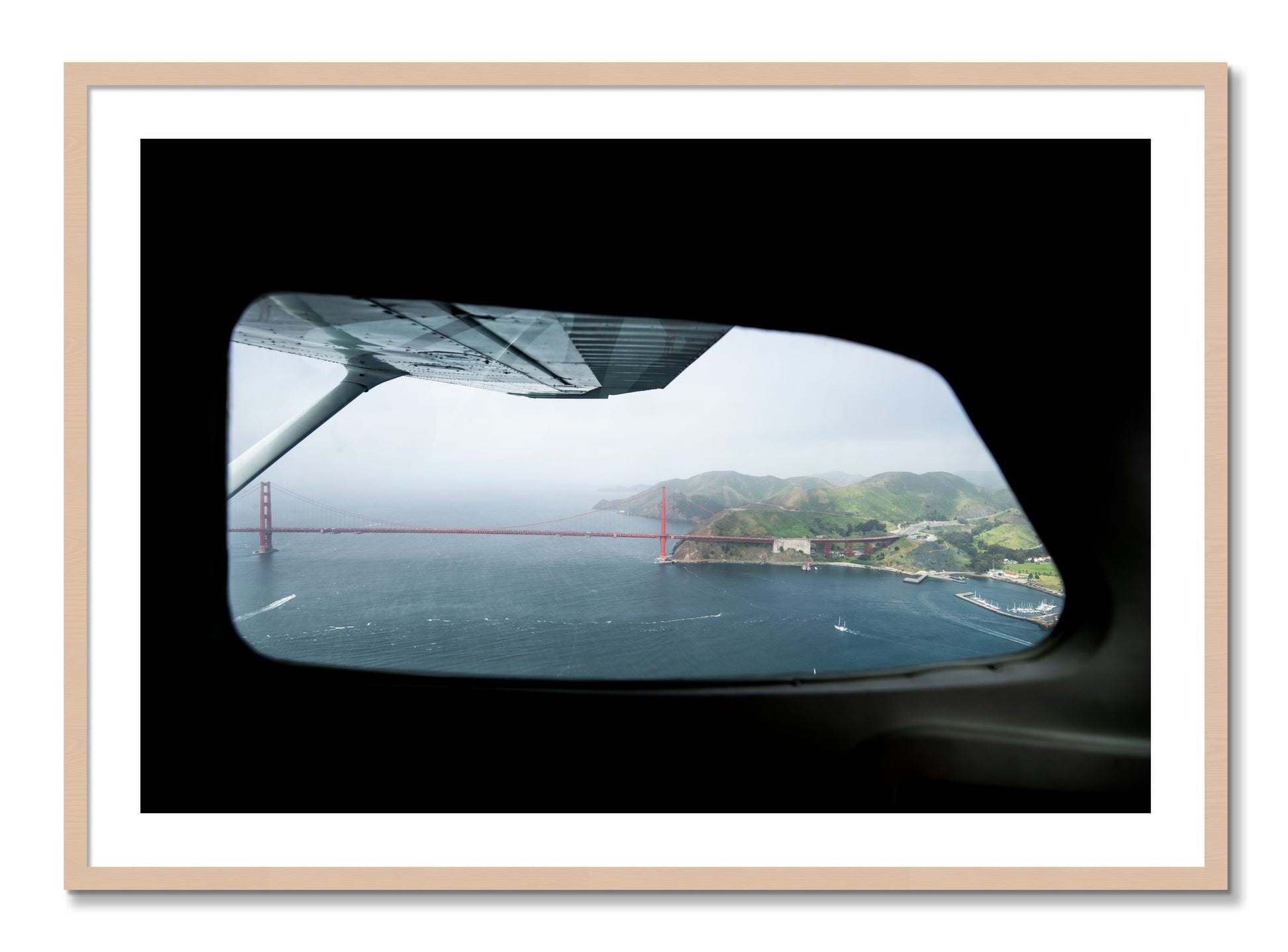 Framed photograph of Flying Over The Gate by Dylan Ozanich, Maple frame, Borders