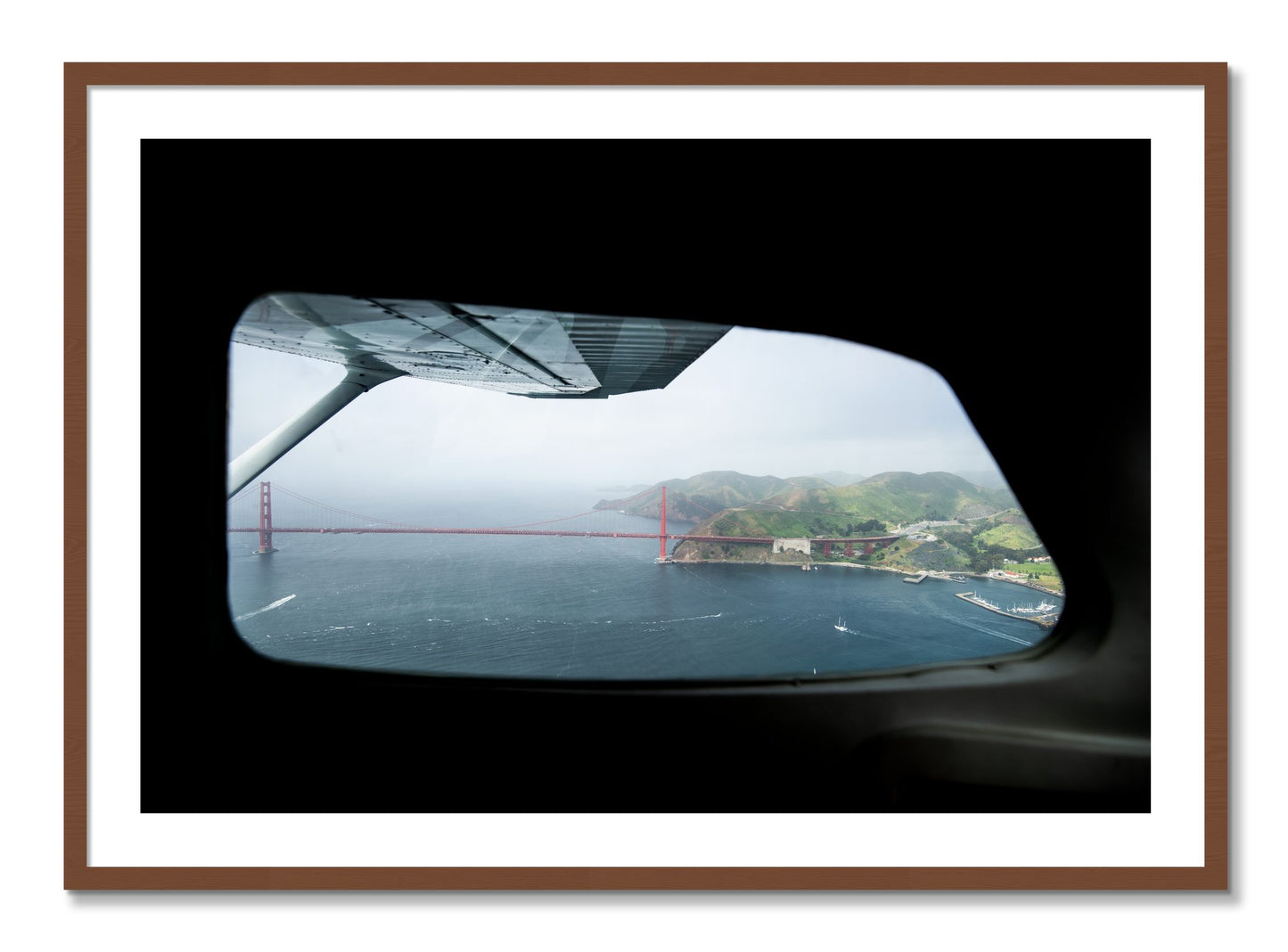 Framed photograph of Flying Over The Gate by Dylan Ozanich, Walnut frame, Borders