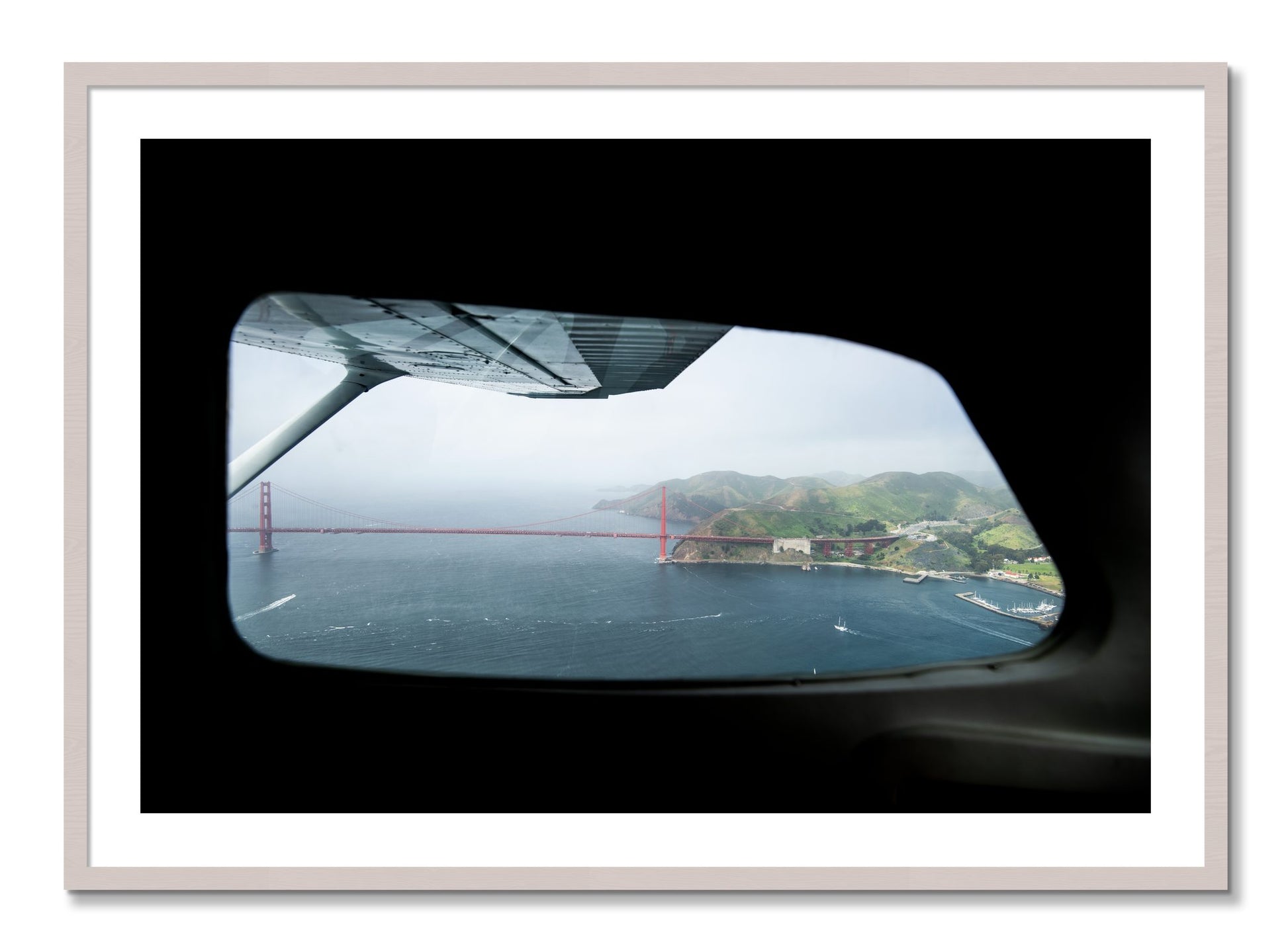 Framed photograph of Flying Over The Gate by Dylan Ozanich, White Maple frame, Borders