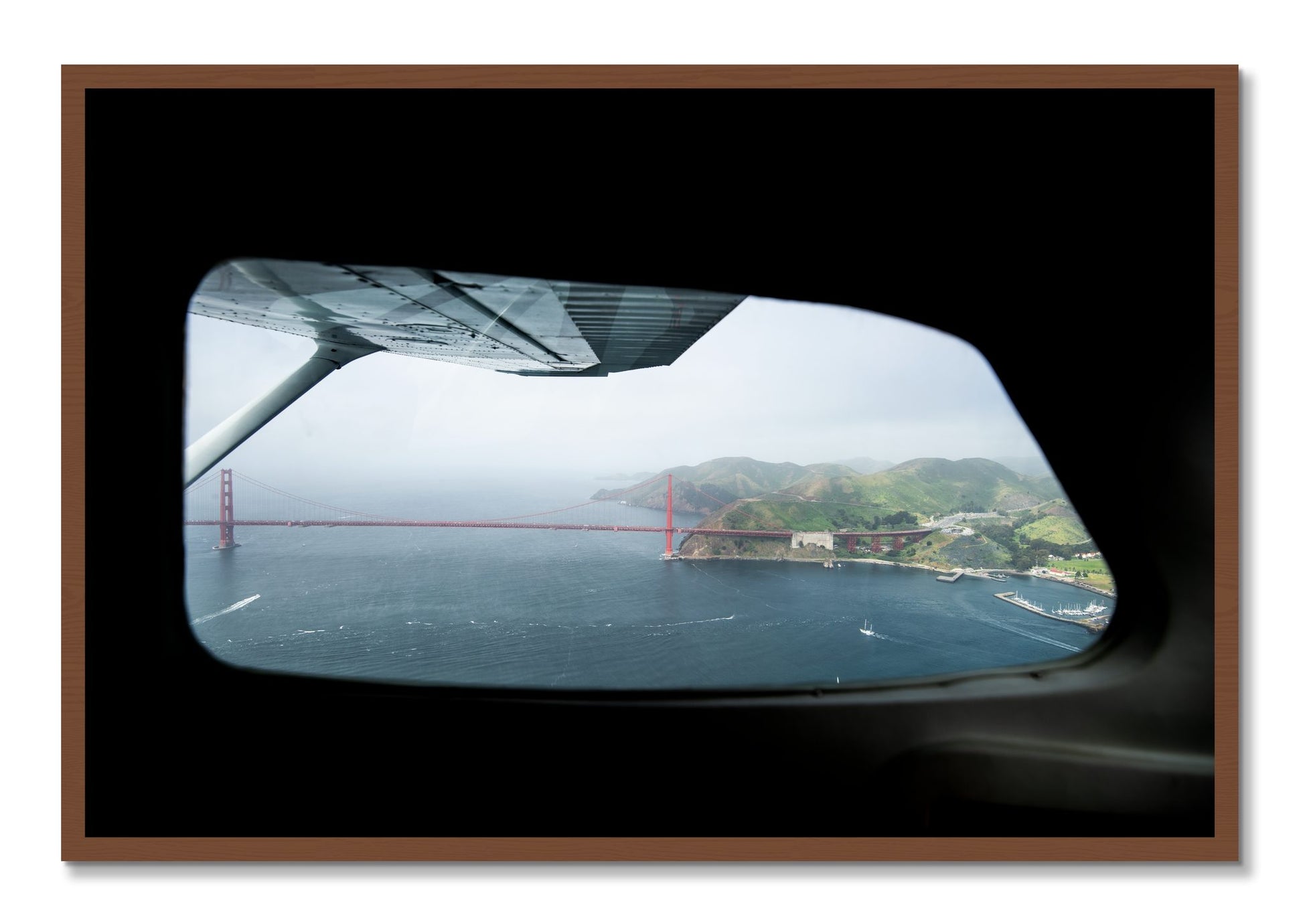 Framed photograph of Flying Over The Gate by Dylan Ozanich, Walnut frame, Full Bleed
