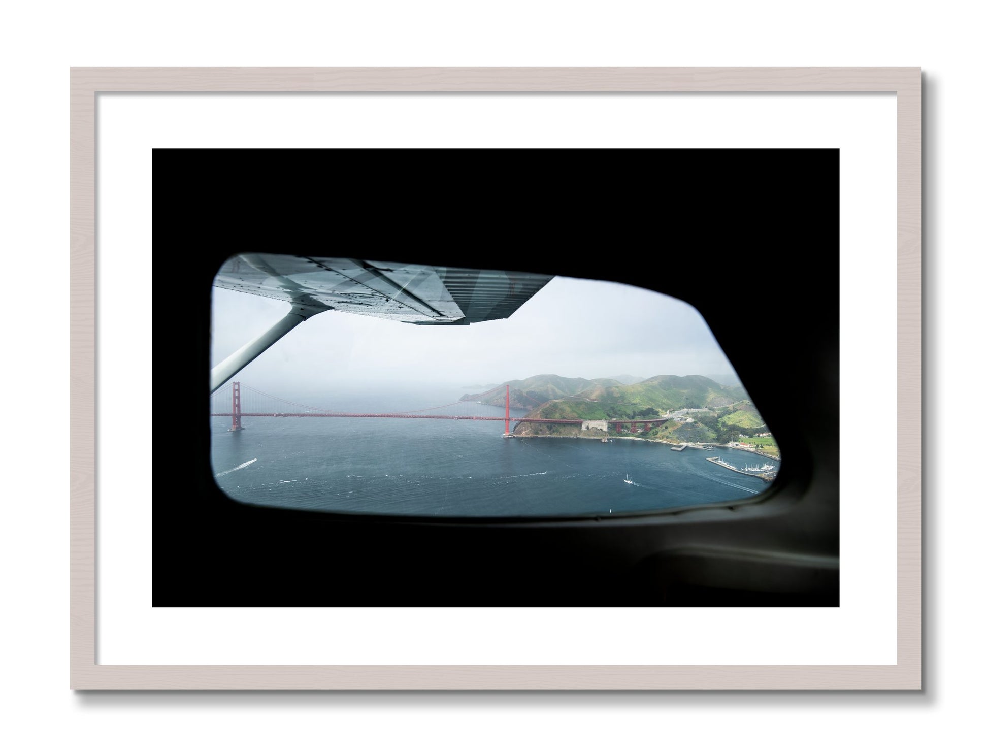 Framed photograph of Flying Over The Gate by Dylan Ozanich, White Maple frame, Borders