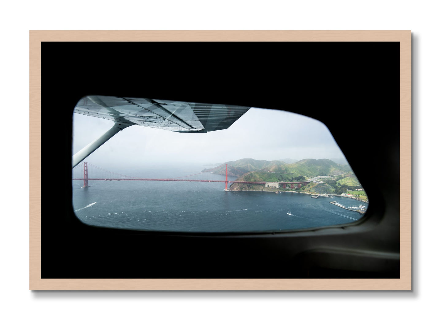 Framed photograph of Flying Over The Gate by Dylan Ozanich, Maple frame, Full Bleed