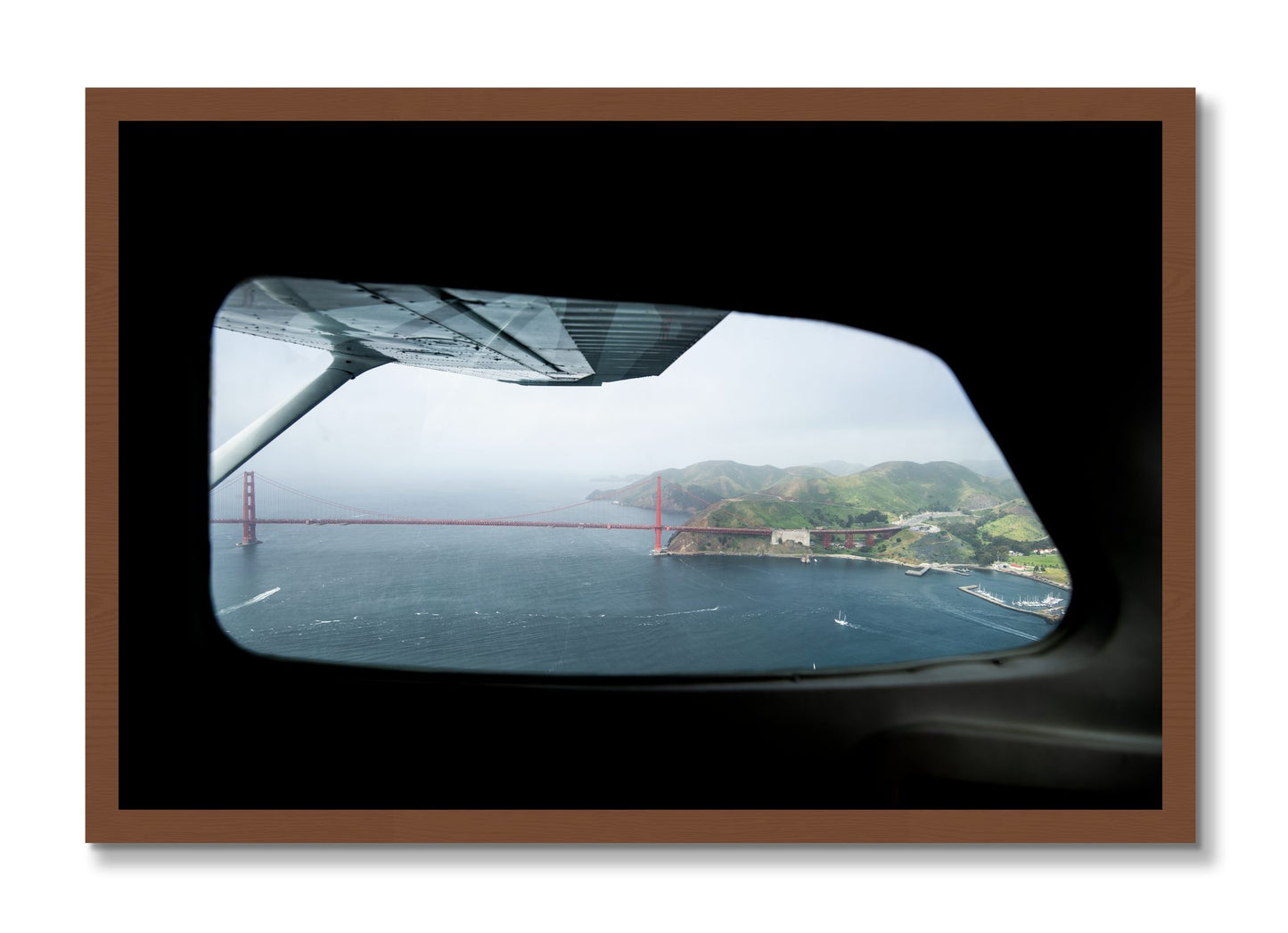 Framed photograph of Flying Over The Gate by Dylan Ozanich, Walnut frame, Full Bleed