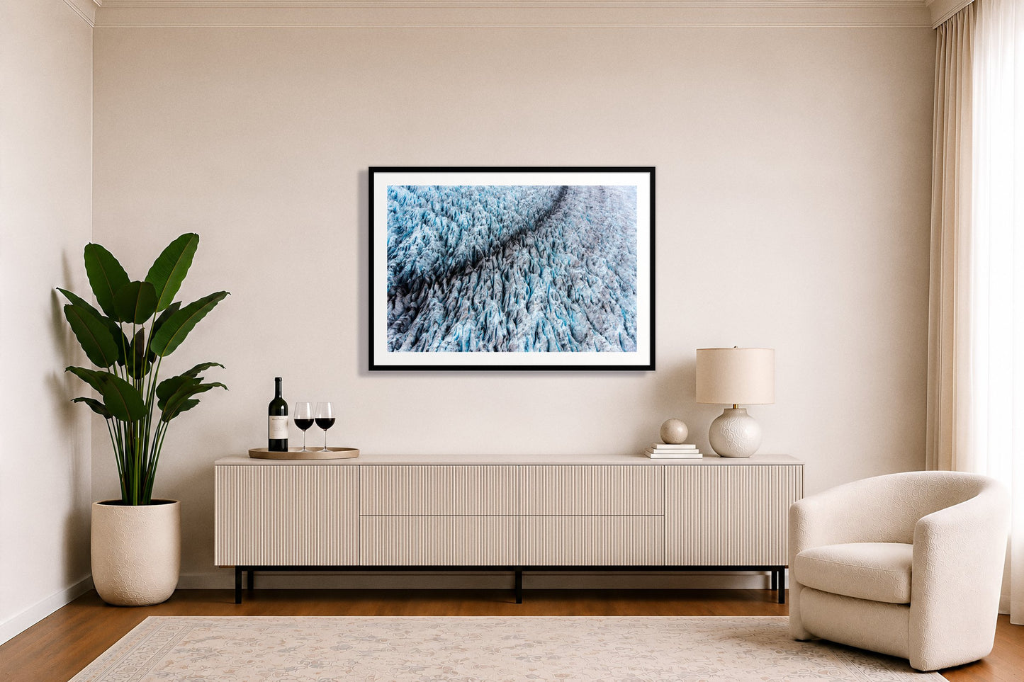 Glacier by Dylan Ozanich in a White frame, above a white fluted credenza in a soft neutral living room