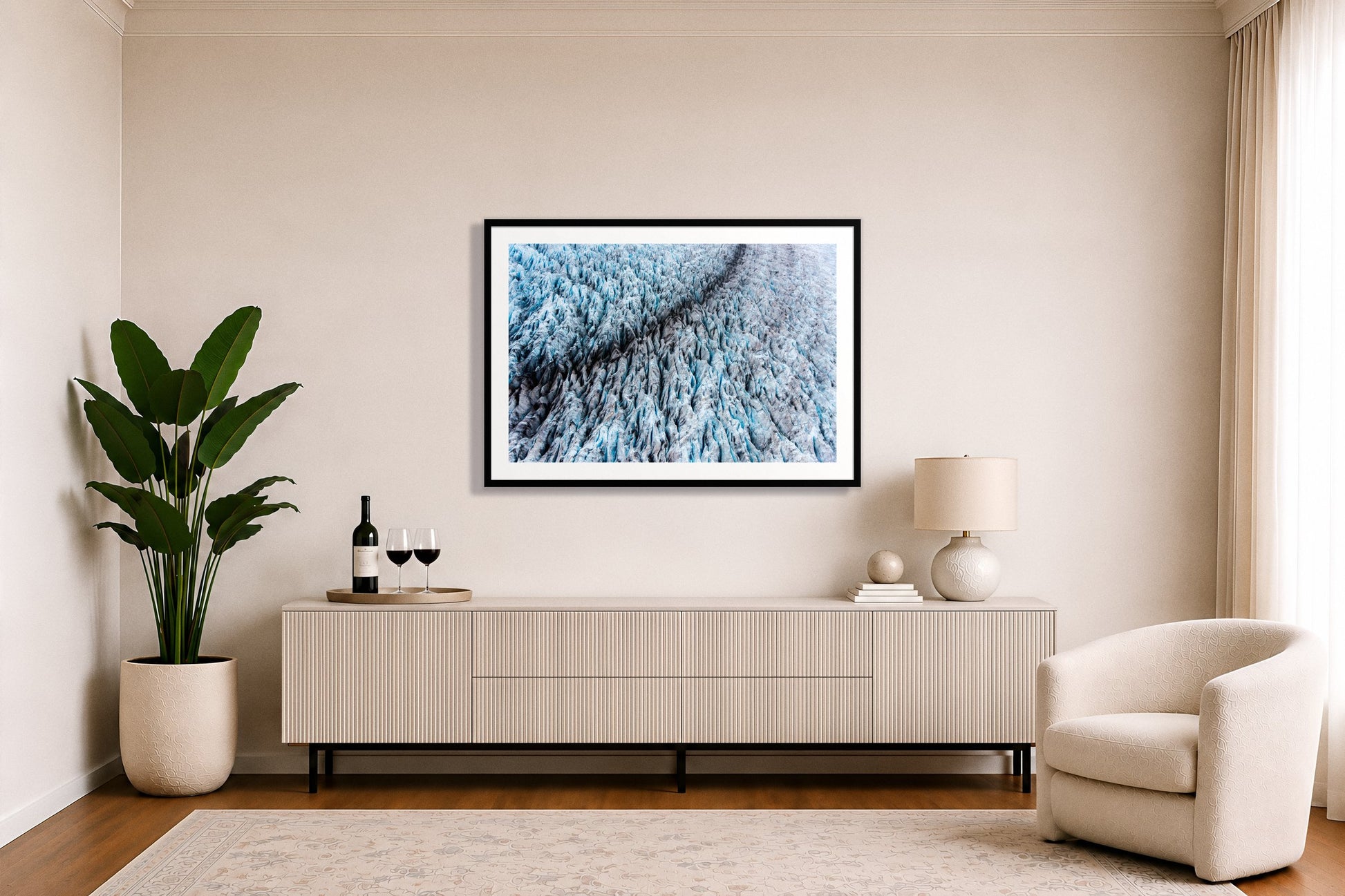 Glacier by Dylan Ozanich in a White frame, above a white fluted credenza in a soft neutral living room