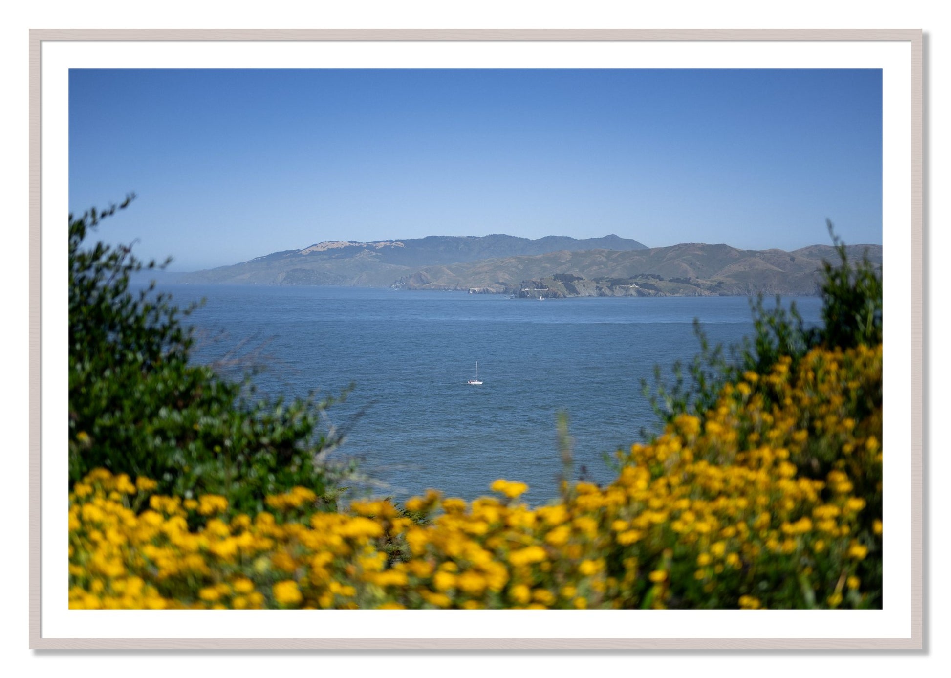 Framed photograph of Golden Bay by Dylan Ozanich, White Maple frame, Borders