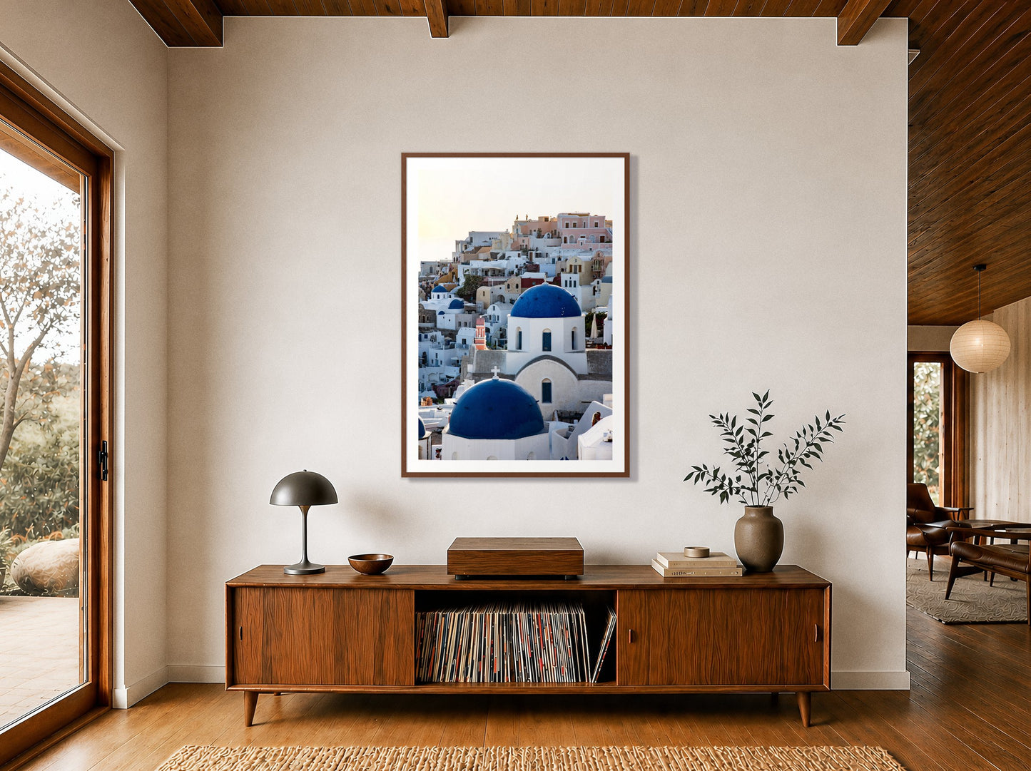 Greek Village by Dylan Ozanich in a Walnut frame, above a walnut record credenza in a wood-beamed midcentury room