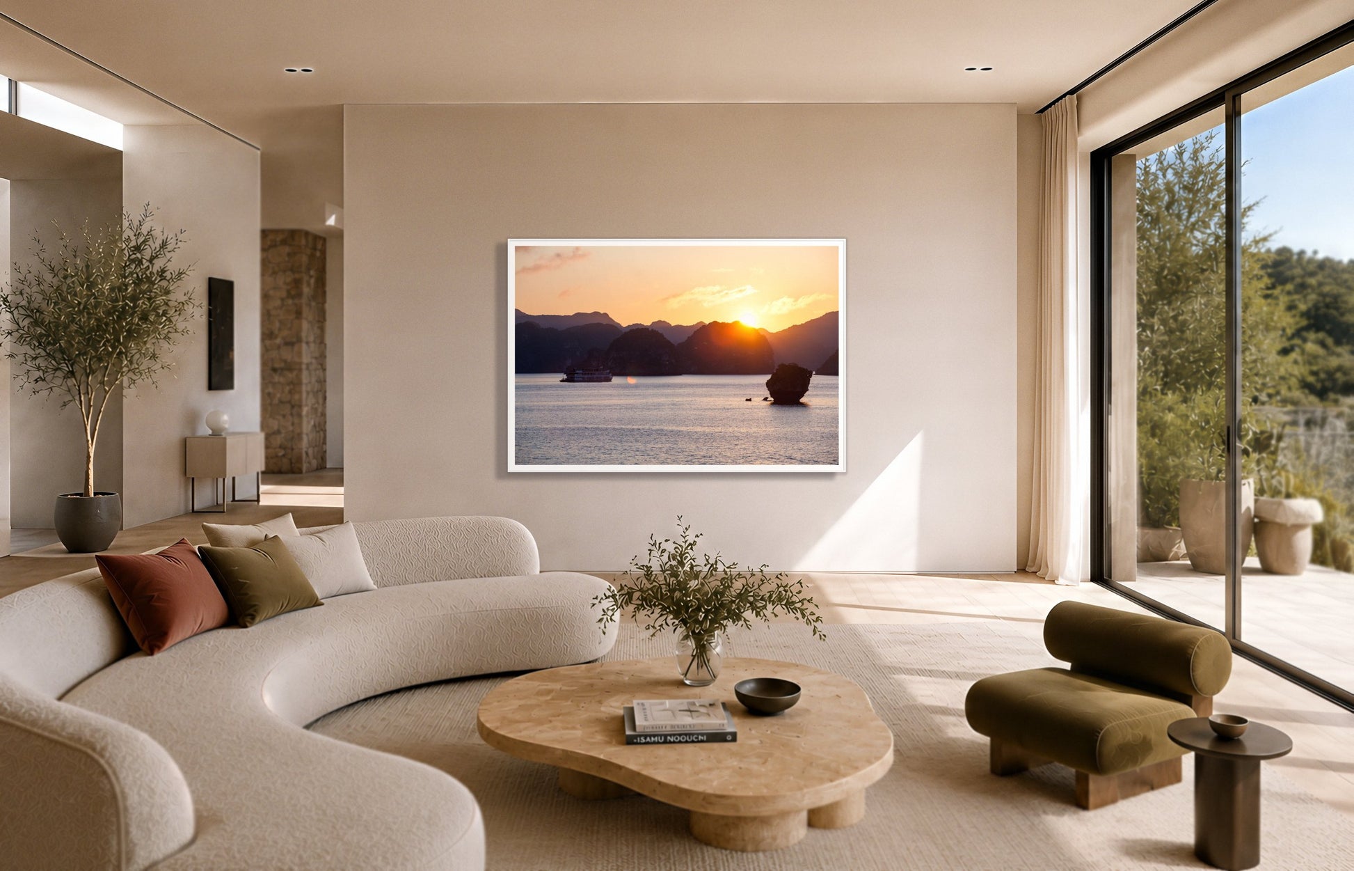 Ha Long Bay by Dylan Ozanich in a White frame, above a cream curved sofa in a sunlit room with olive velvet seating