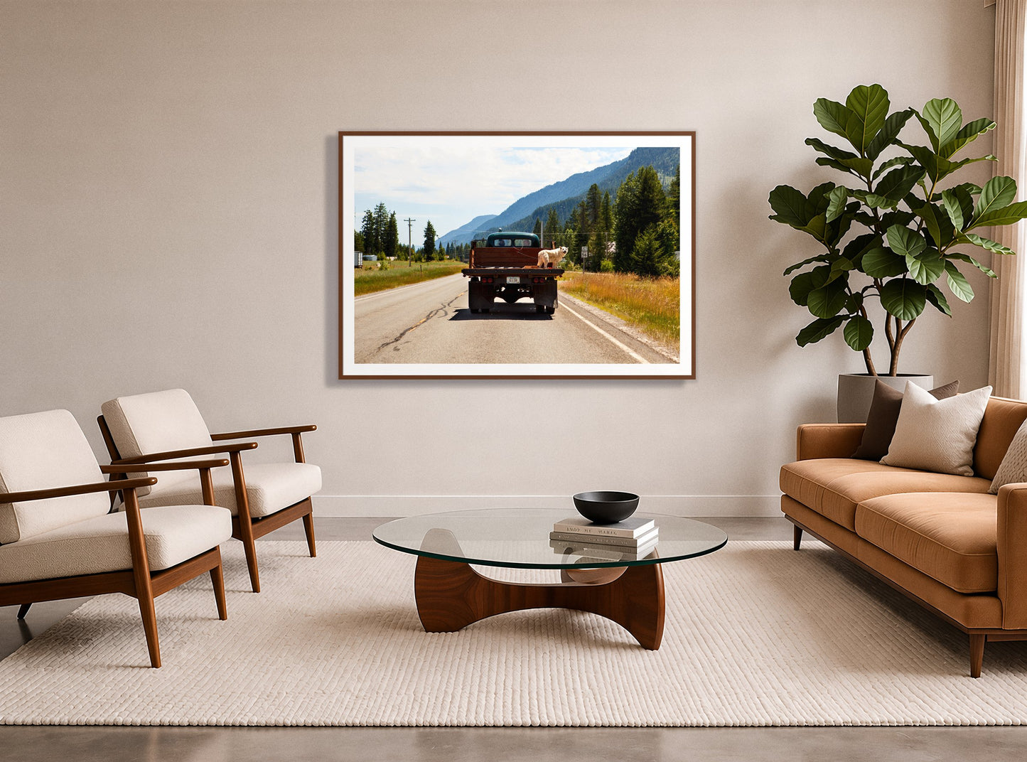 Heading To Town by Dylan Ozanich in a Walnut frame, in a midcentury living room with a tan leather sofa and fiddle-leaf fig