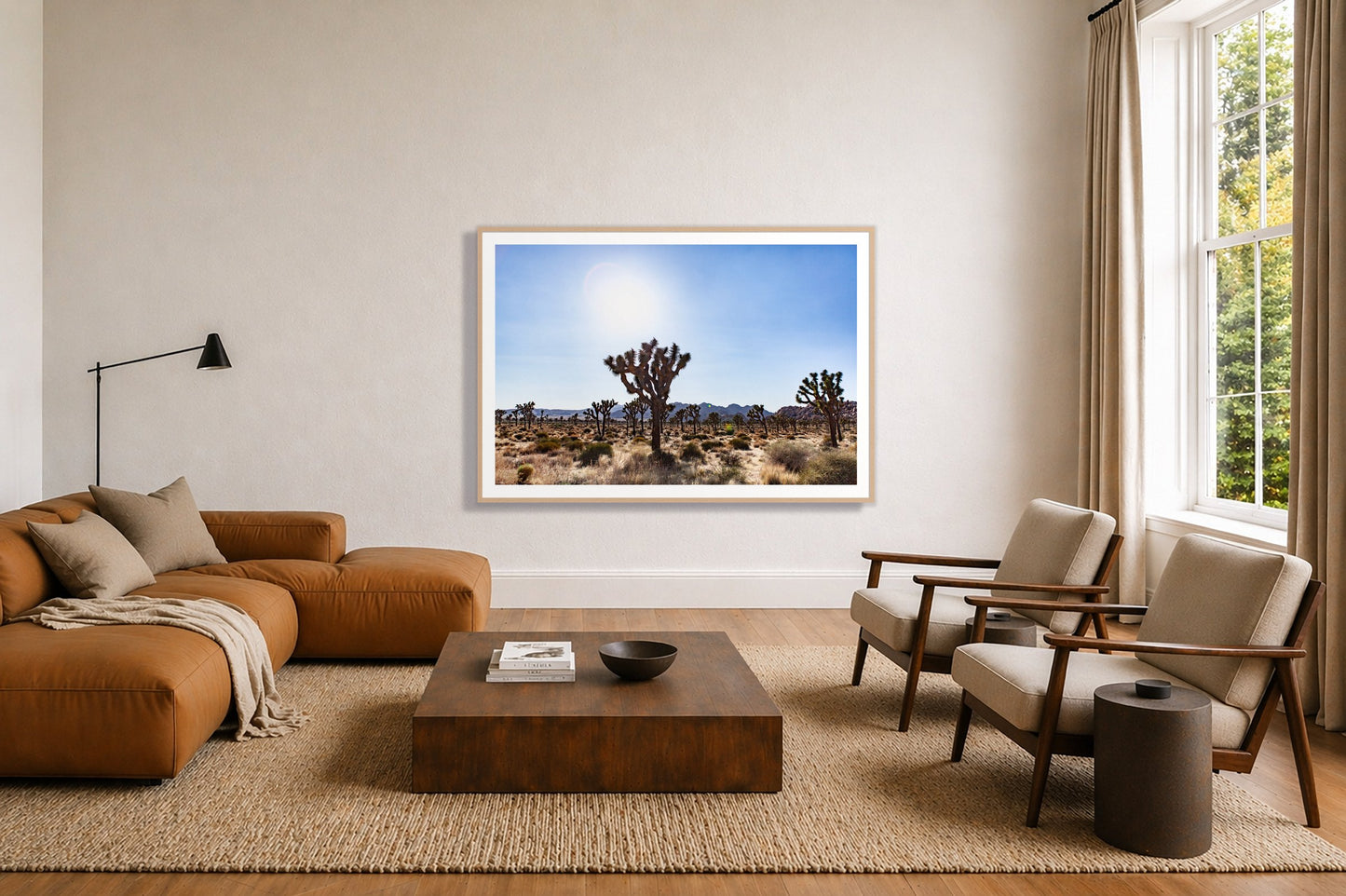Joshua Tree by Dylan Ozanich in an Oak frame, above a tan modular leather sofa in a minimal, sunlit living room