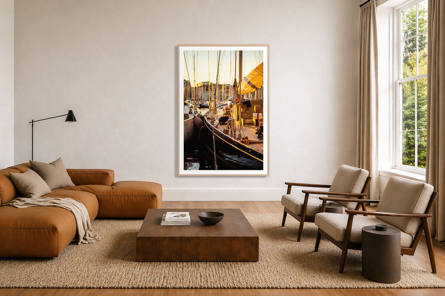 Nice France by Dylan Ozanich in an Oak frame, above a tan modular leather sofa in a minimal, sunlit living room
