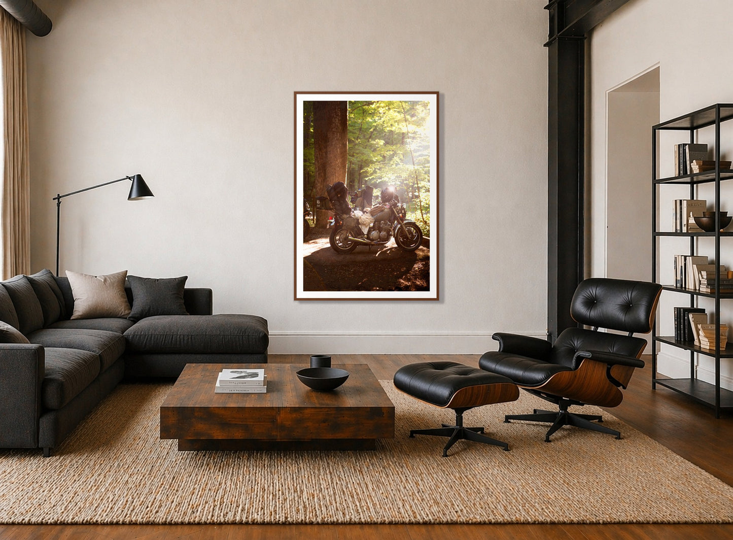 Pack Up And Go by Dylan Ozanich in a Walnut frame, above a dark sectional in a loft with a black leather lounge chair