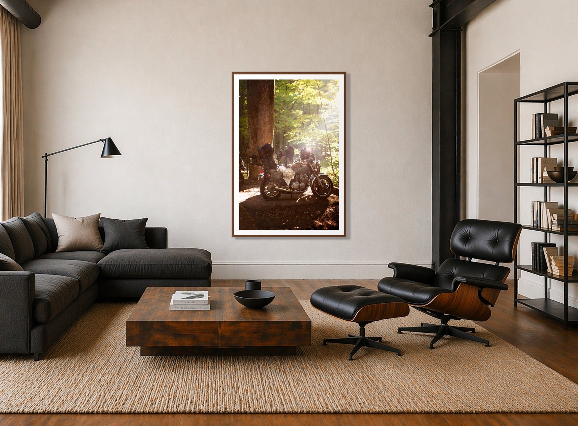 Pack Up And Go by Dylan Ozanich in a Walnut frame, above a dark sectional in a loft with a black leather lounge chair