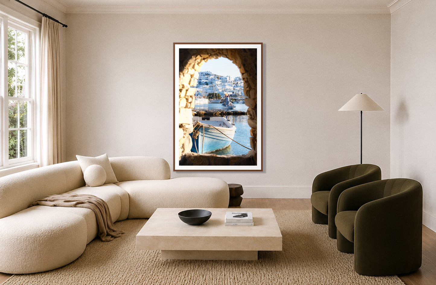 Paros Greece by Dylan Ozanich in a Walnut frame, above a cream curved sofa in a living room with olive velvet armchairs