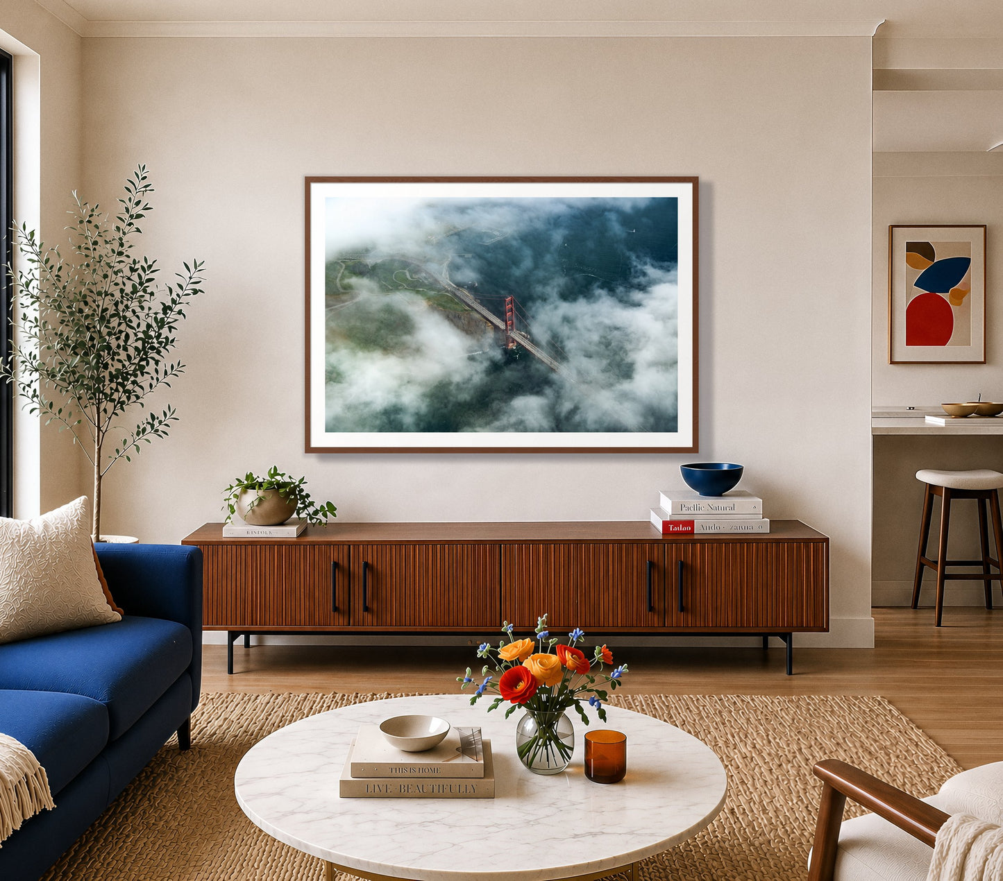 Peaking Through by Dylan Ozanich in a Walnut frame, above a walnut credenza in a bright living room with a blue sofa