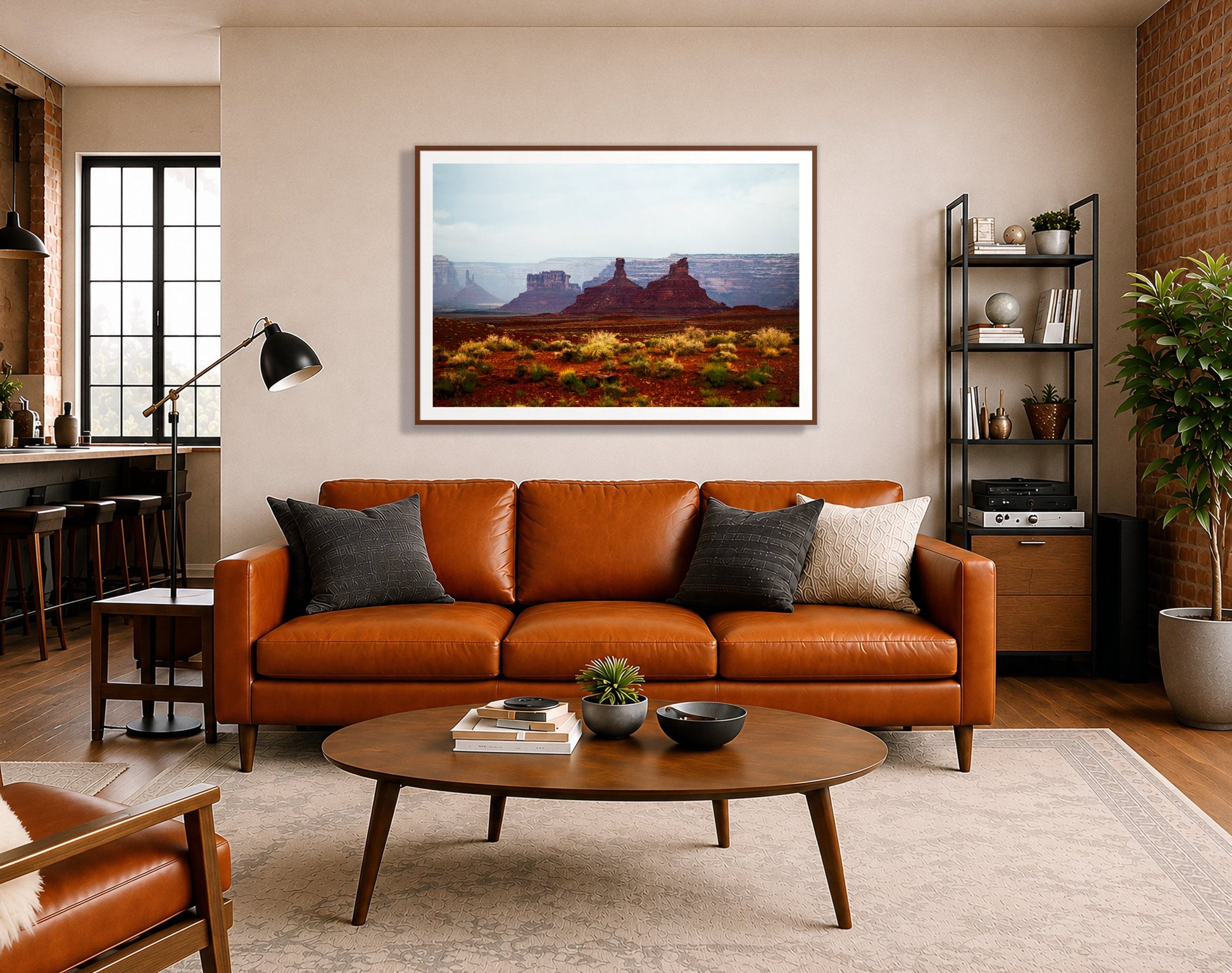 Pillars by Dylan Ozanich in a Walnut frame, above a cognac leather sofa in a brick loft