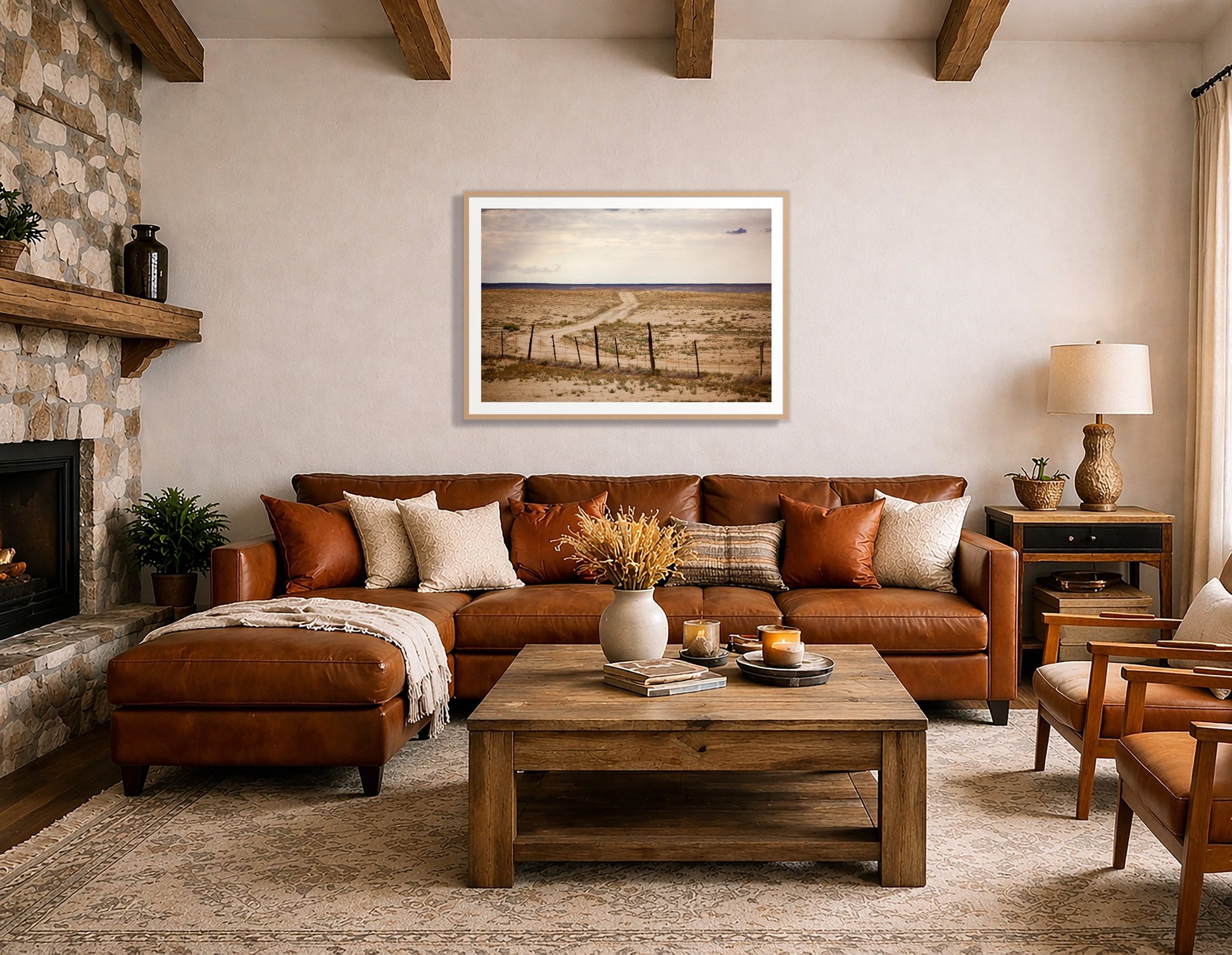 Road To Nowhere by Dylan Ozanich in an Oak frame, beside a stone fireplace above a brown leather sectional