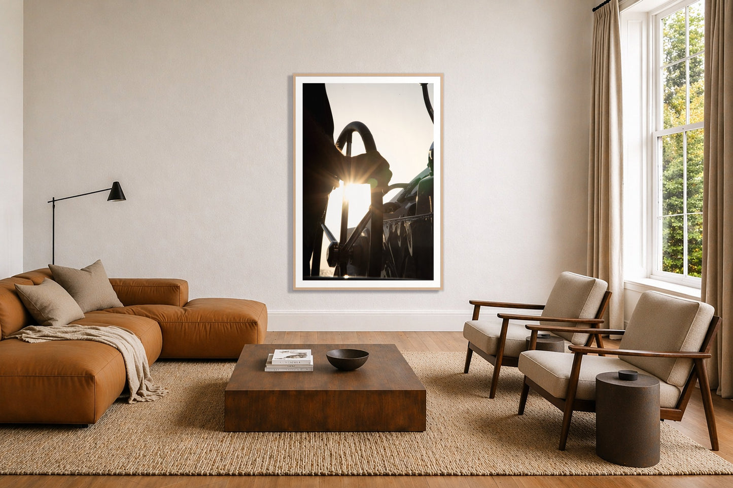 Sailing by Dylan Ozanich in an Oak frame, above a tan modular leather sofa in a minimal, sunlit living room