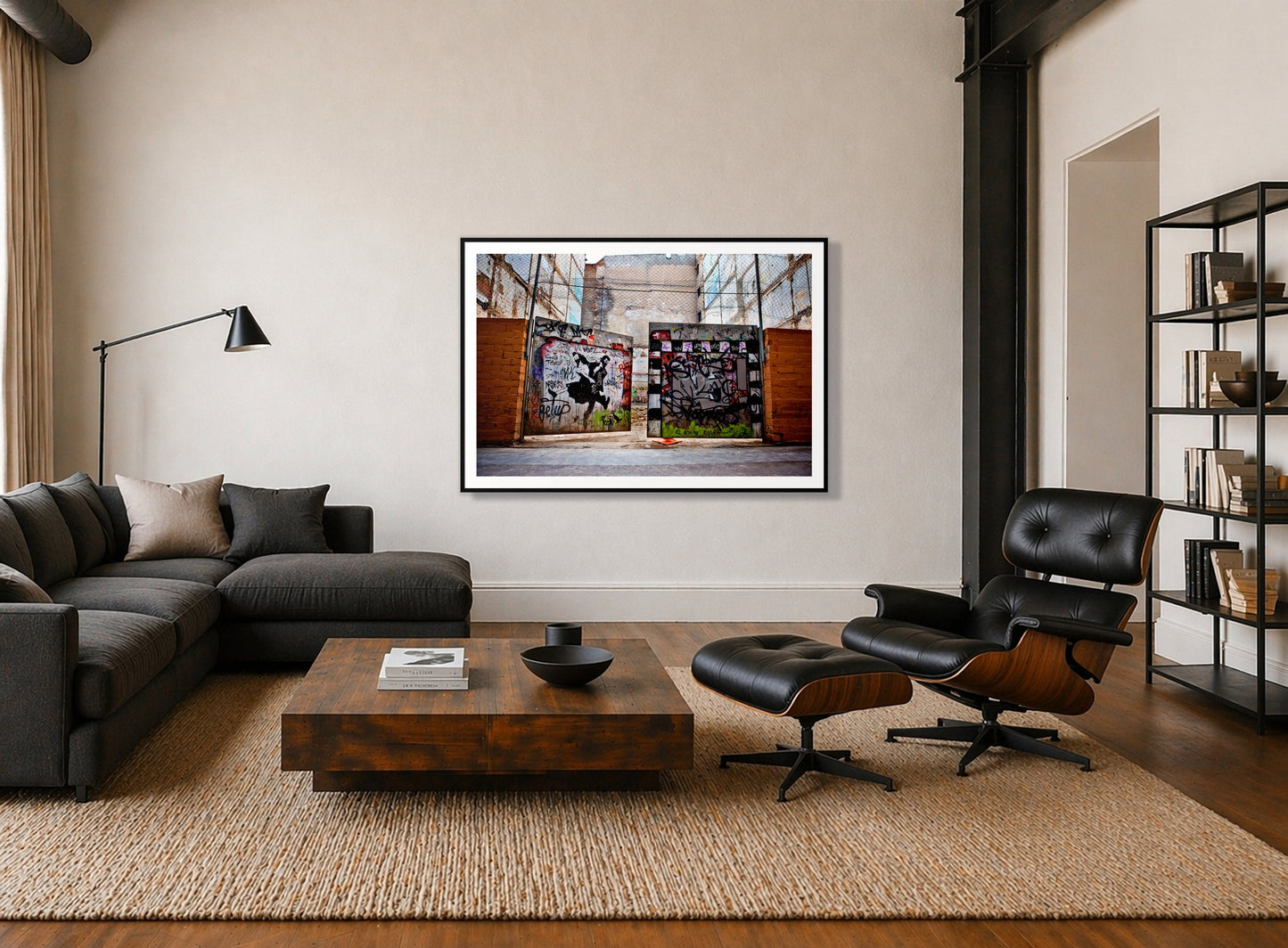 The Dance by Dylan Ozanich in a Black frame, above a dark sectional in a loft with a black leather lounge chair