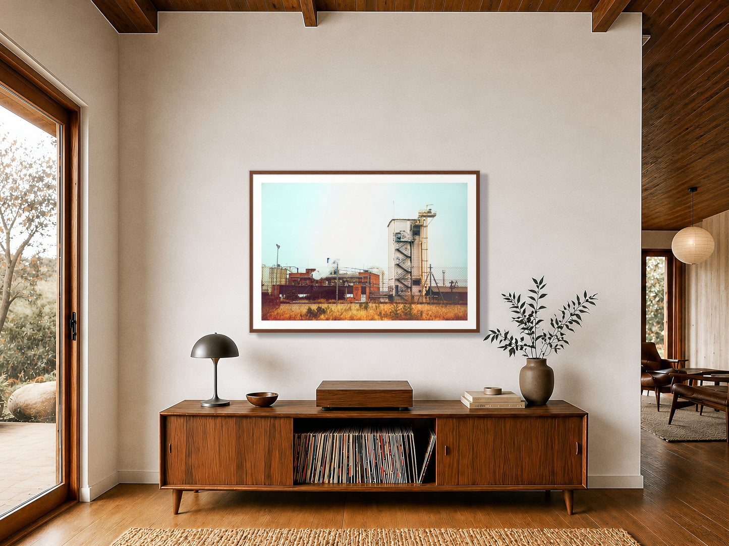 Train Ride by Dylan Ozanich in a Walnut frame, above a walnut record credenza in a wood-beamed midcentury room