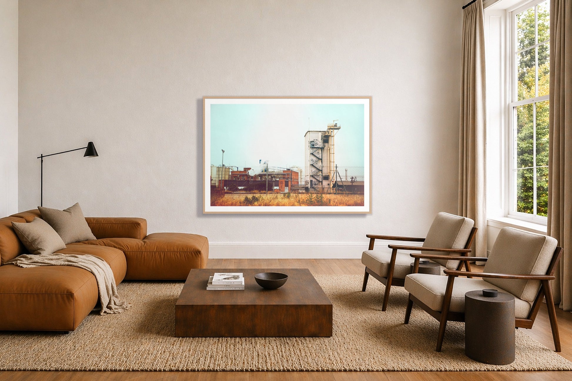 Train Ride by Dylan Ozanich in an Oak frame, above a tan modular leather sofa in a minimal, sunlit living room