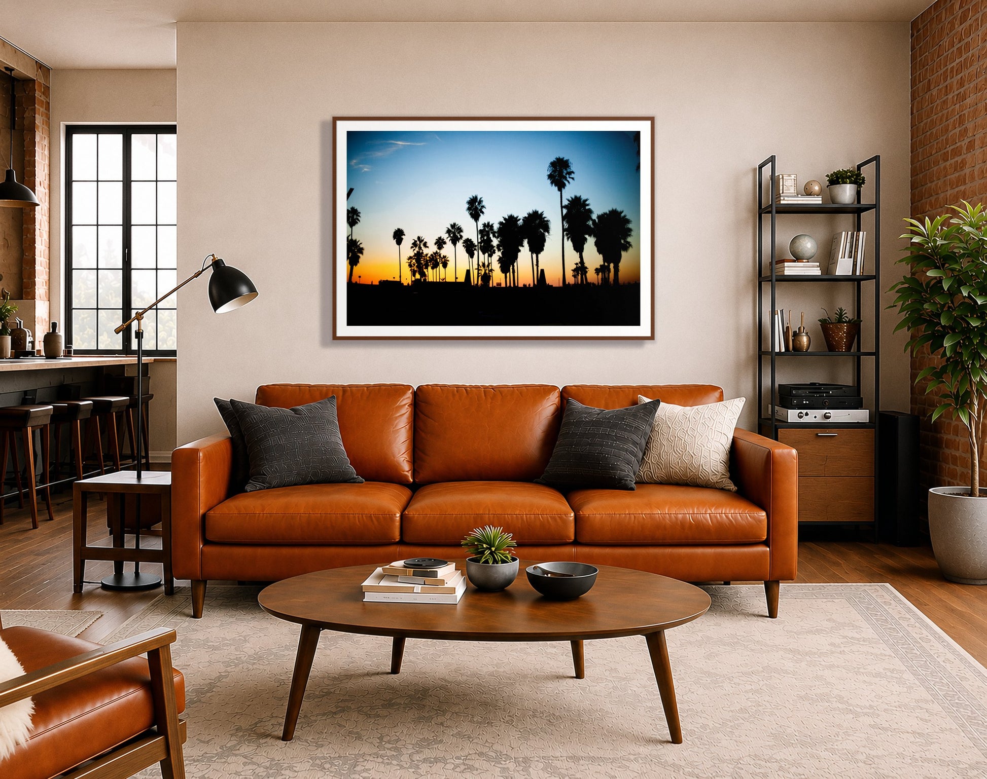 Venice Beach by Dylan Ozanich in a Walnut frame, above a cognac leather sofa in a brick loft