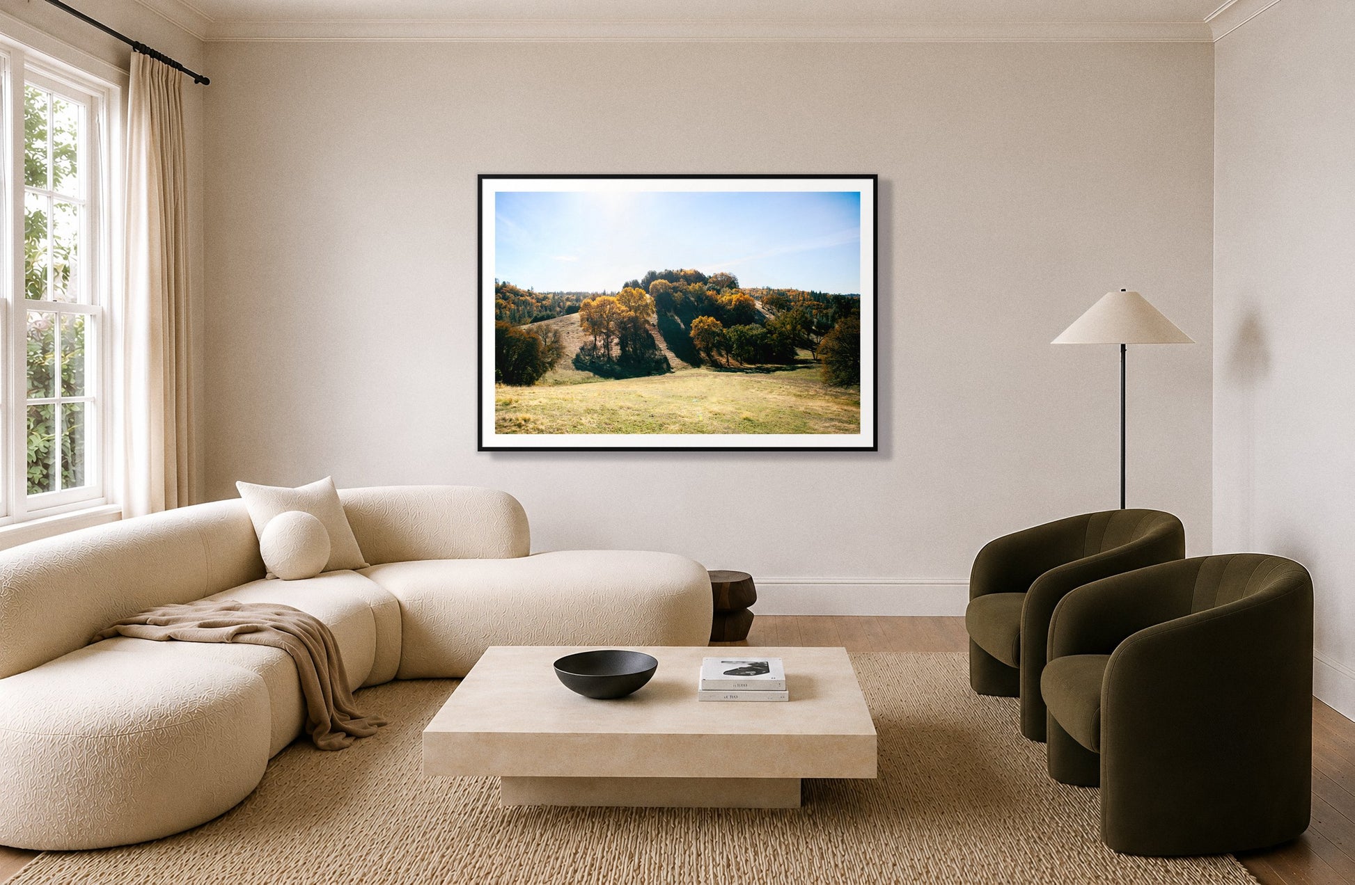 Where IGrew Up by Dylan Ozanich in a Black frame, above a cream curved sofa in a living room with olive velvet armchairs