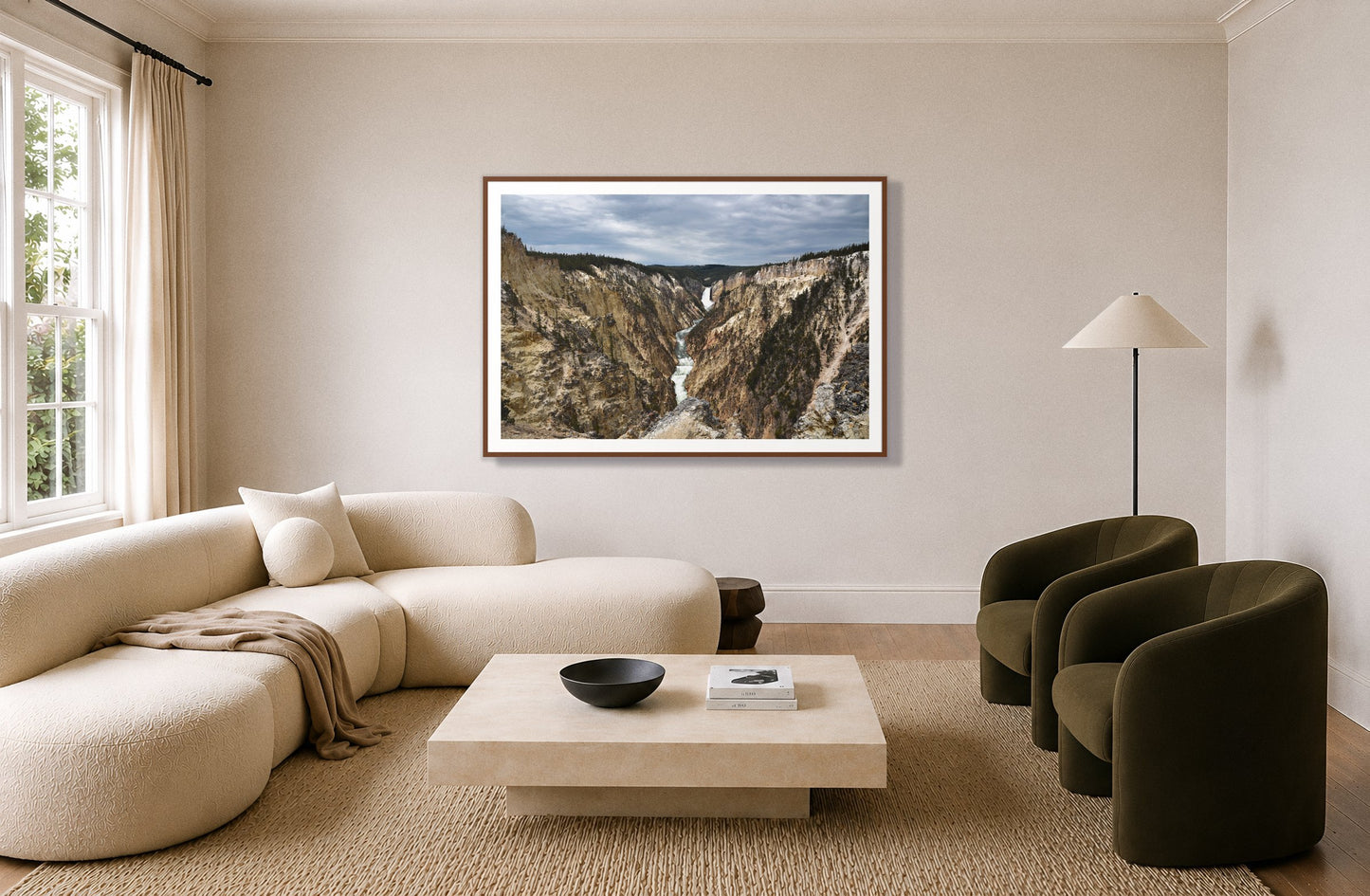 Wyoming by Dylan Ozanich in a Walnut frame, above a cream curved sofa in a living room with olive velvet armchairs