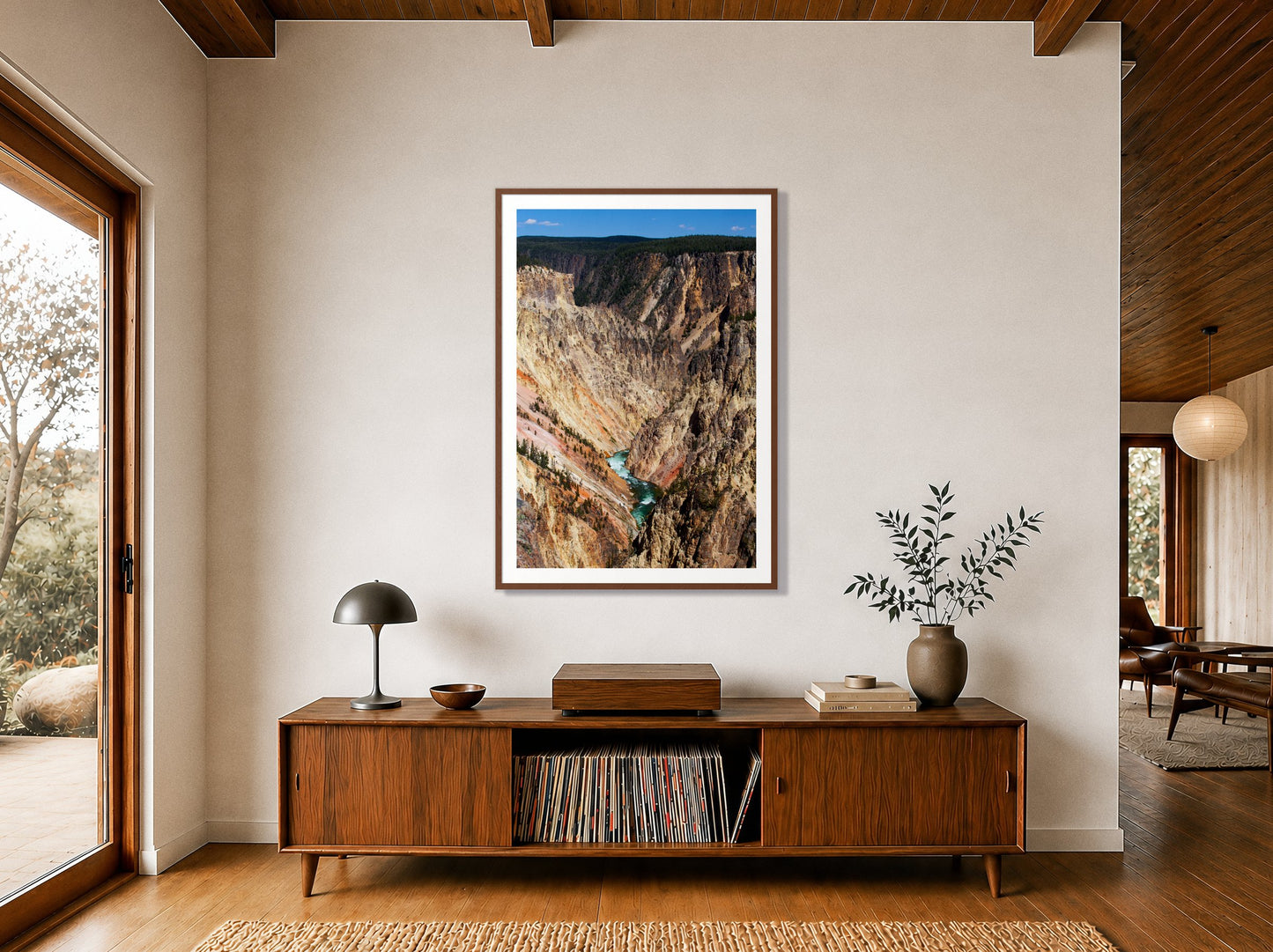 Yellowstone Canyon by Dylan Ozanich in a Walnut frame, above a walnut record credenza in a wood-beamed midcentury room